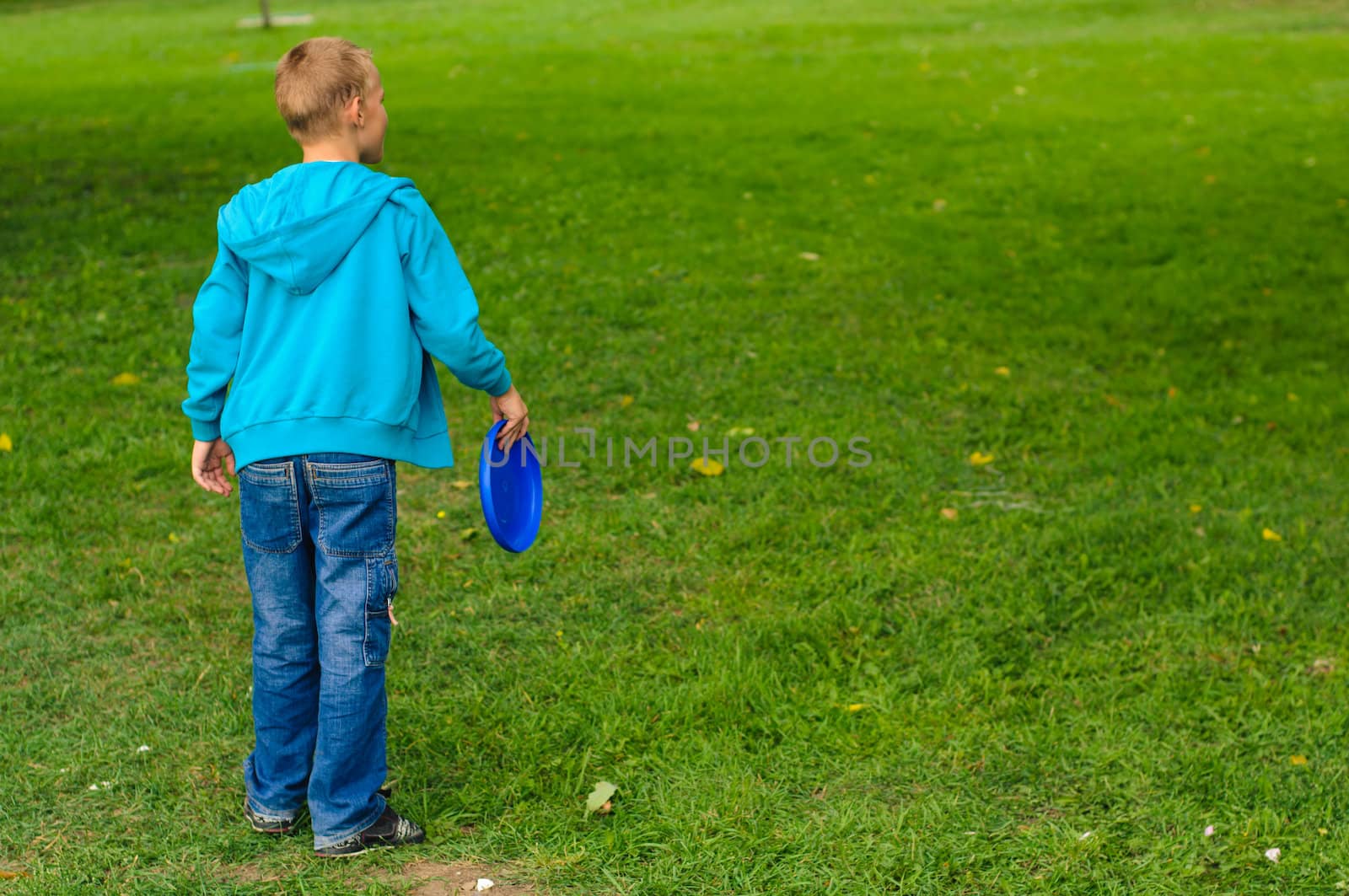 Little boy playing frisbee by nvelichko