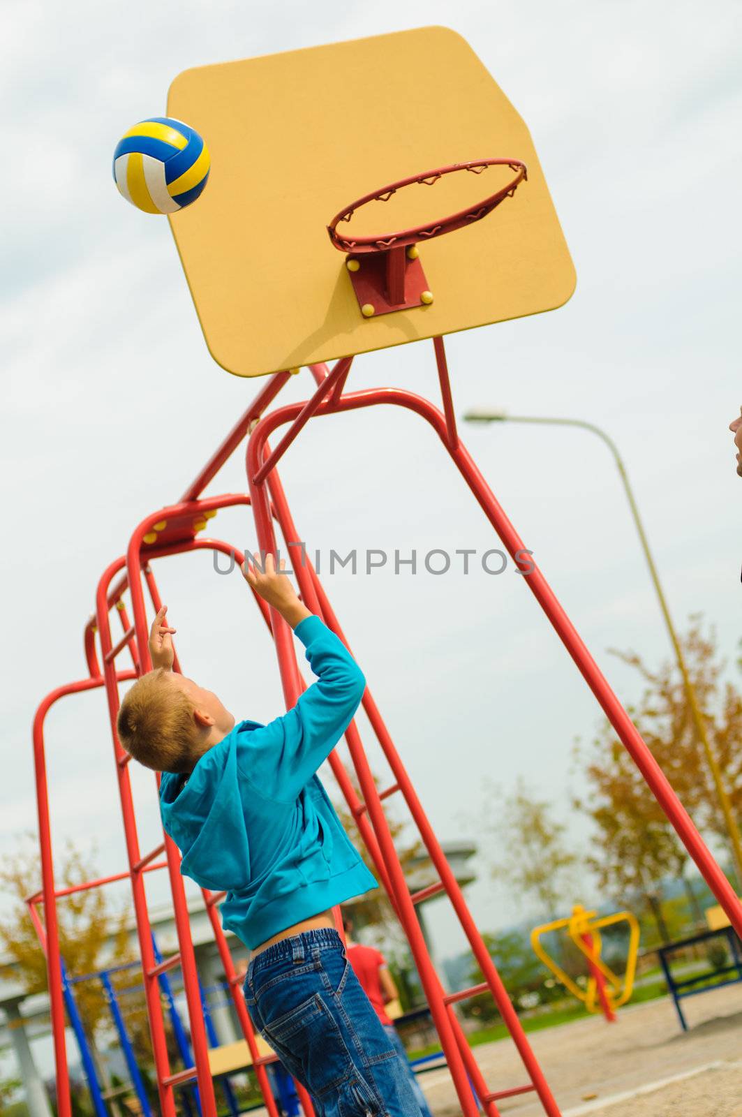 Young boy playing basketball at outdoors playground