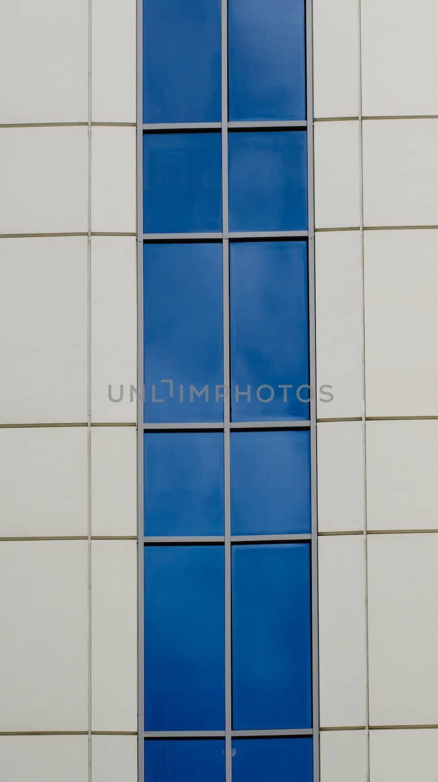 Blue sky reflected in the windows of office building