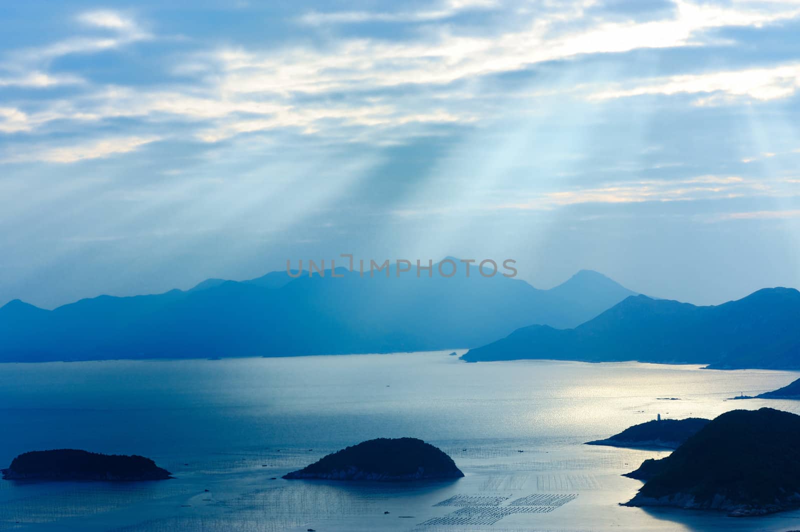 Ocean landscape with sunshine, islands and mountains