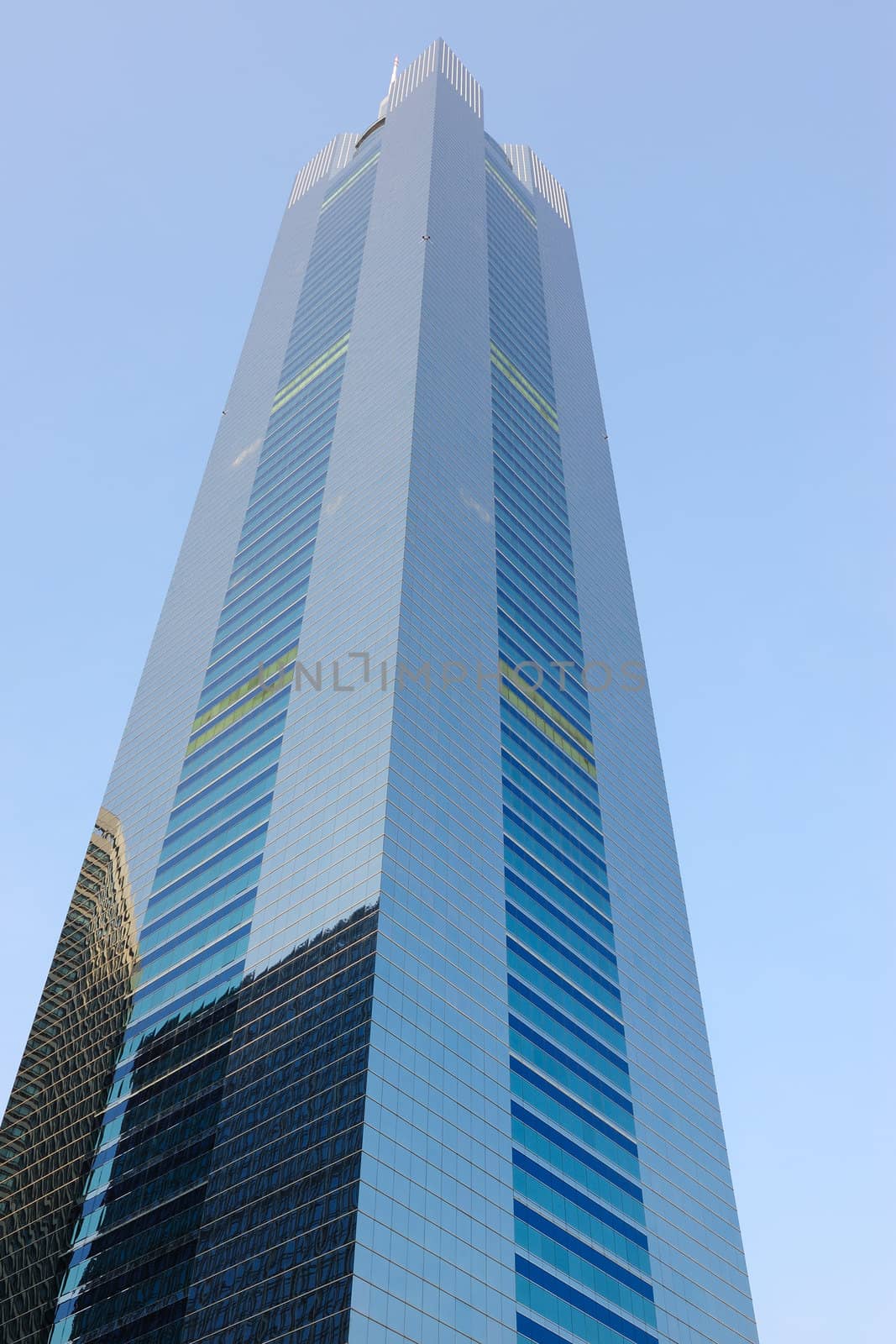 Perspective shot of a modern skyscraper under the blue sky