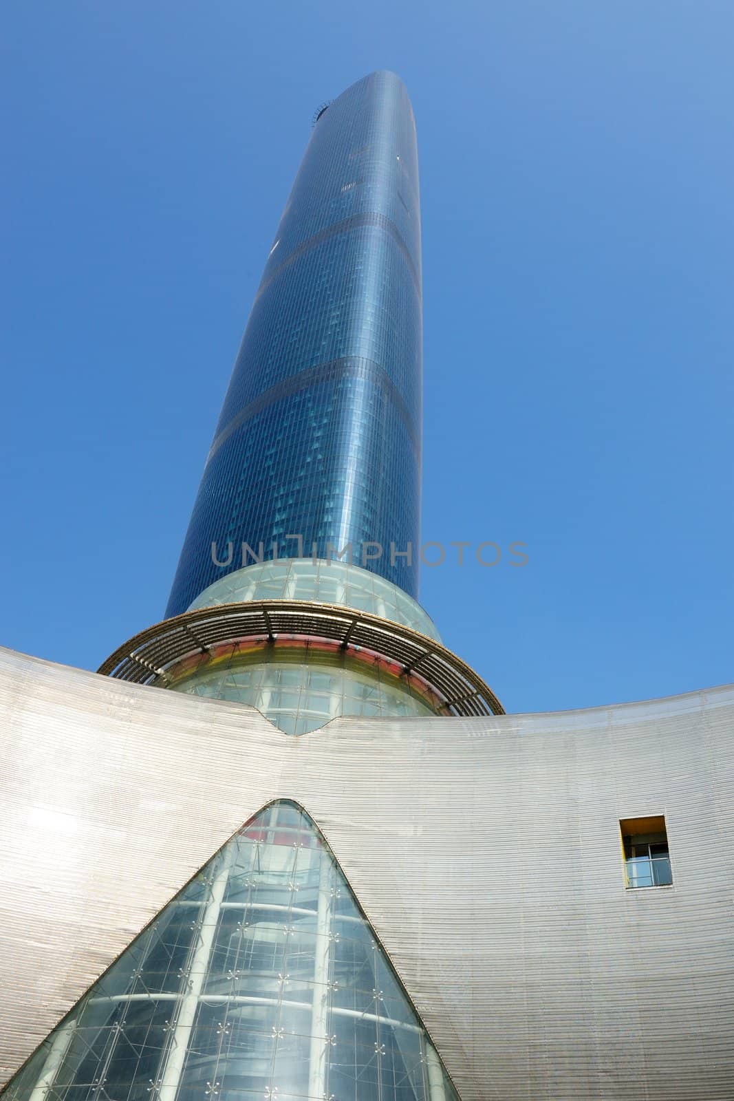 Perspective shot of a modern skyscraper under the blue sky