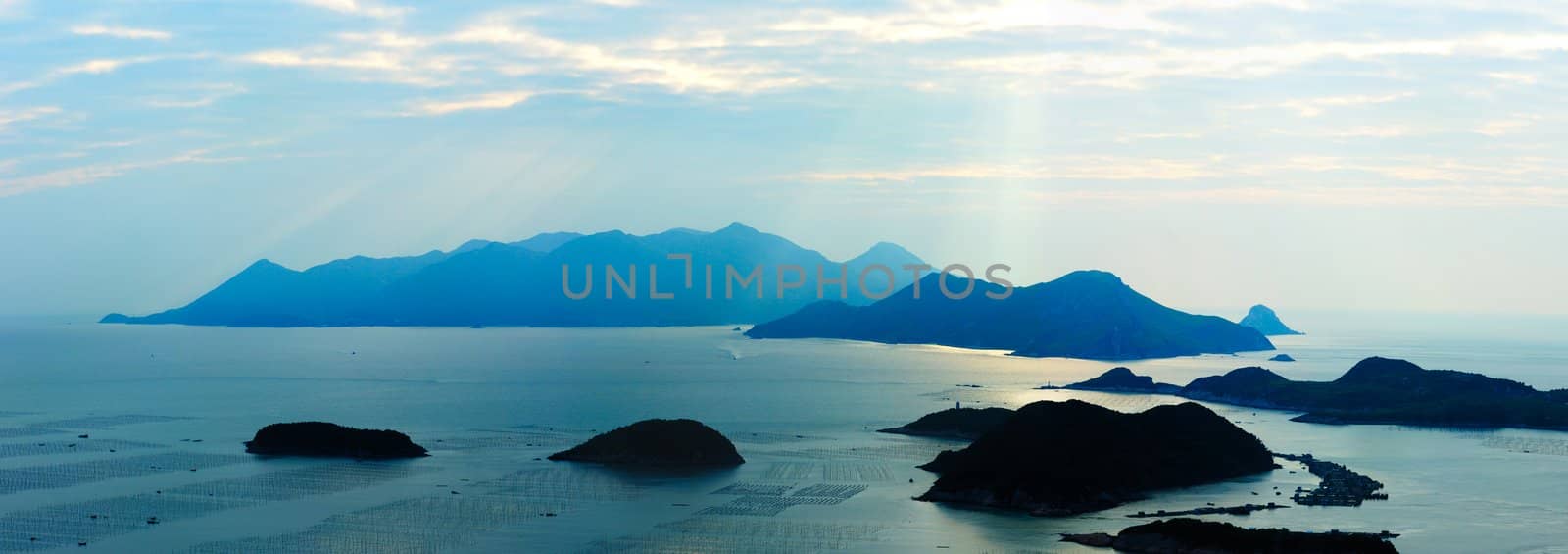 Ocean landscape with sunshine, islands and mountains