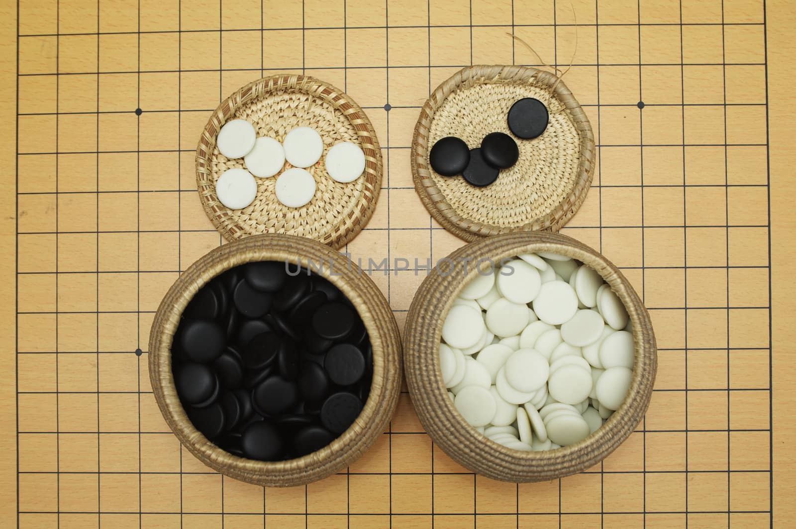 Go game board , black and white stones and boxes