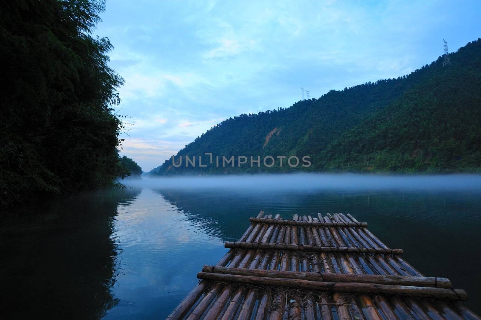 River landscape at sunset with fog rolling across the chilly river water, photo taken in Hunan province of China