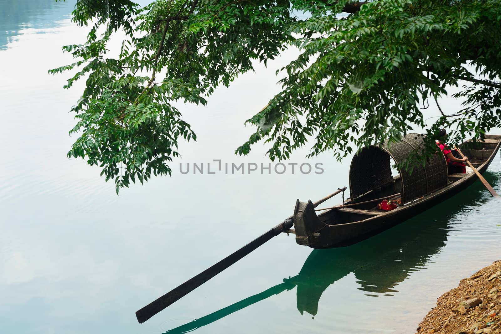 Fishing boat on the river under the tree in Hunan province of China