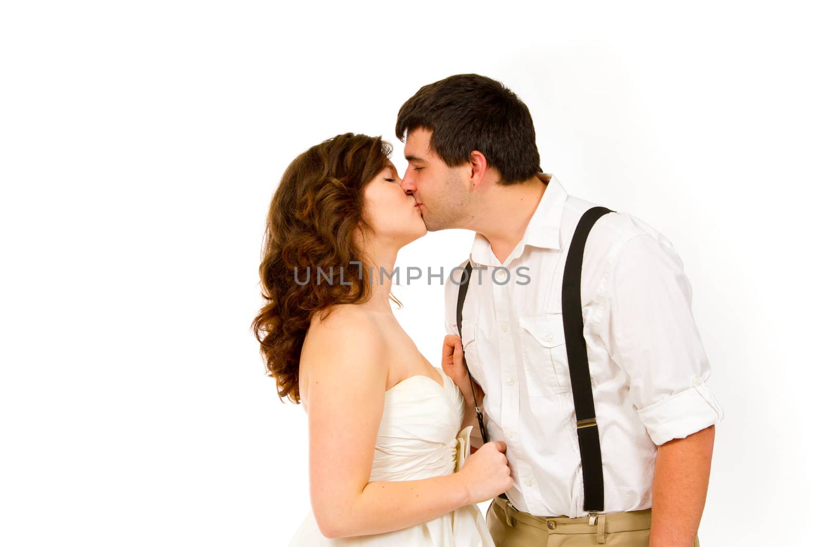 An attractive woman and her handsome husband wear their wedding attire in the studio agains an isolated white background.