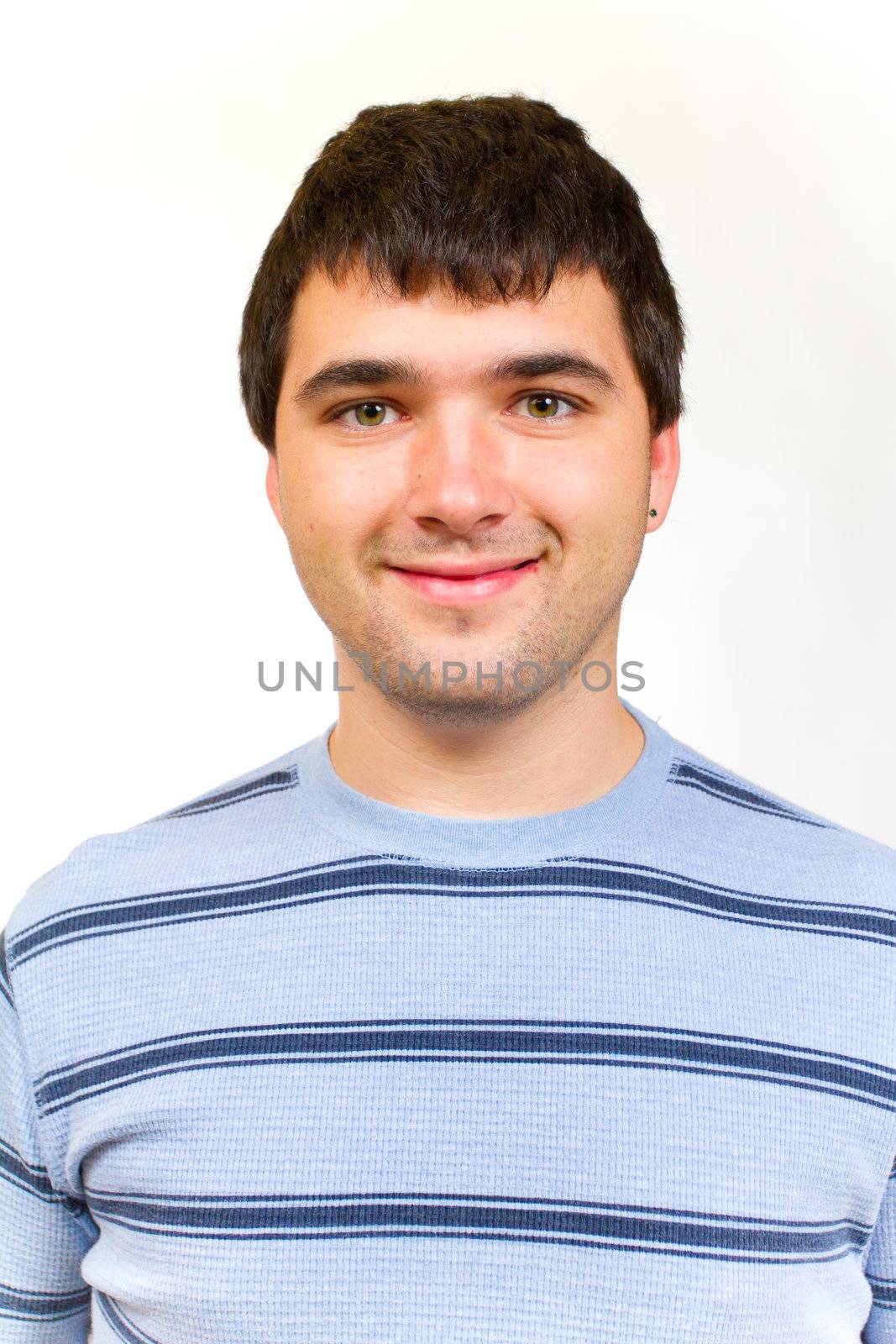 A portrait of a man in a striped sweater in the studio against an isolated white background.