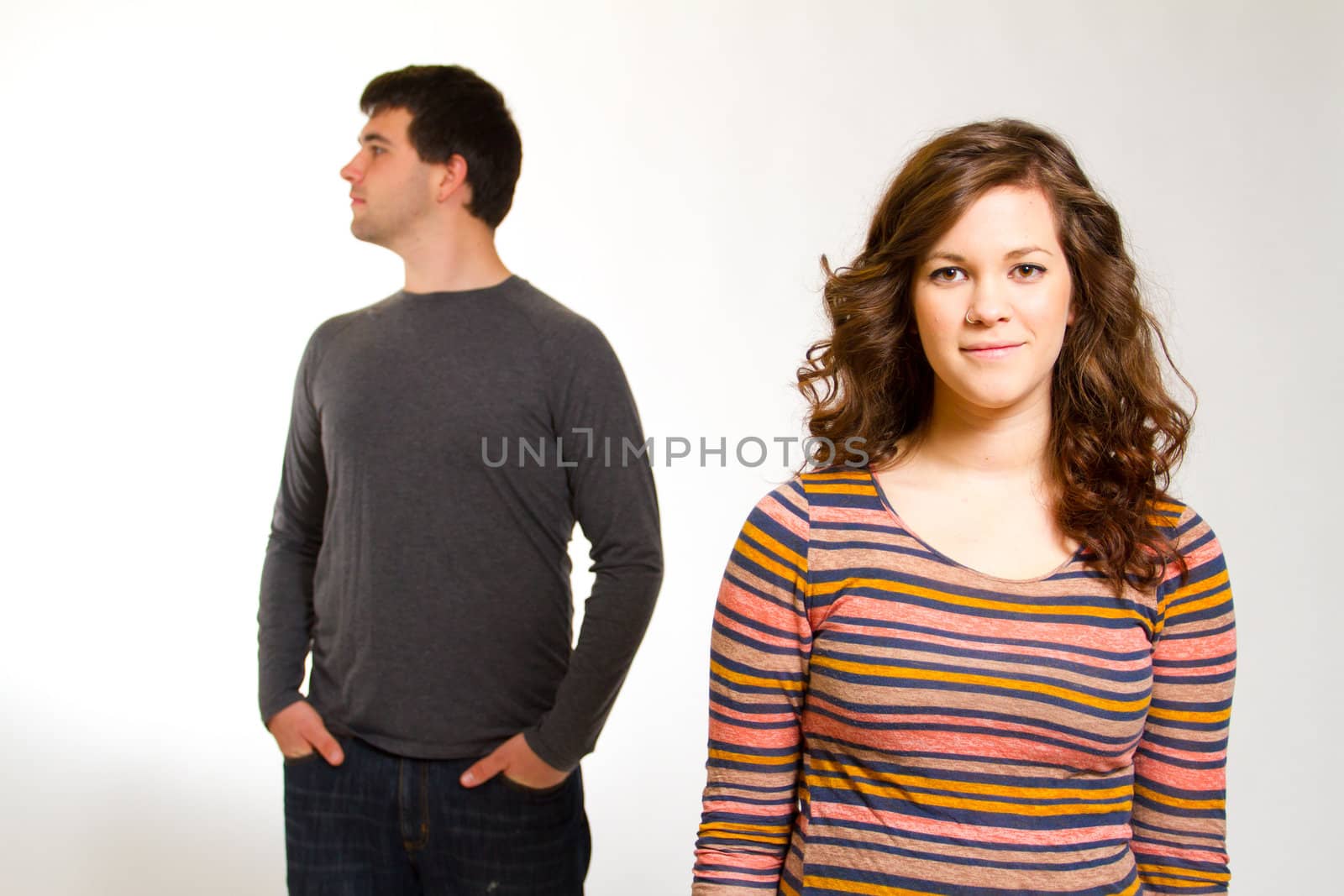 A man and a woman in a studio against an isolated white background for this simple portrait.