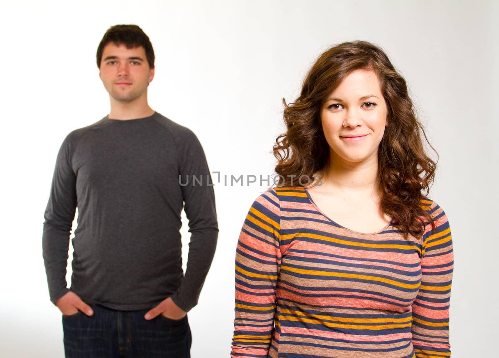 A man and a woman in a studio against an isolated white background for this simple portrait.