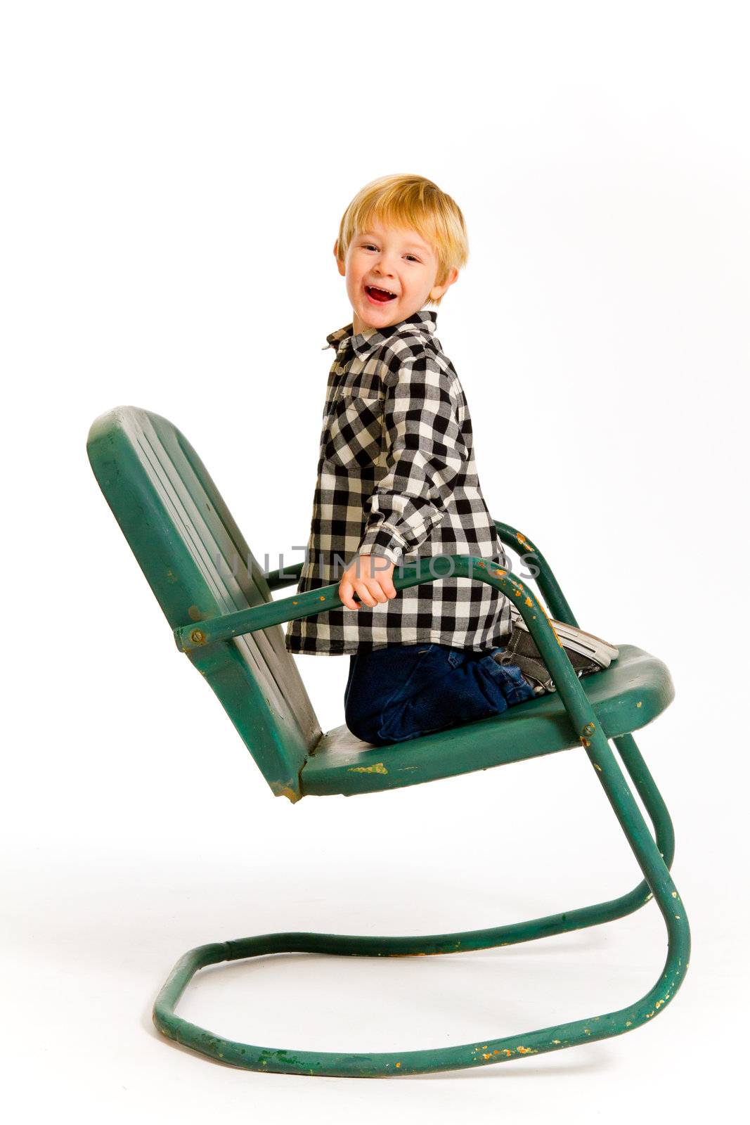 Boy Having Fun On Chair by joshuaraineyphotography