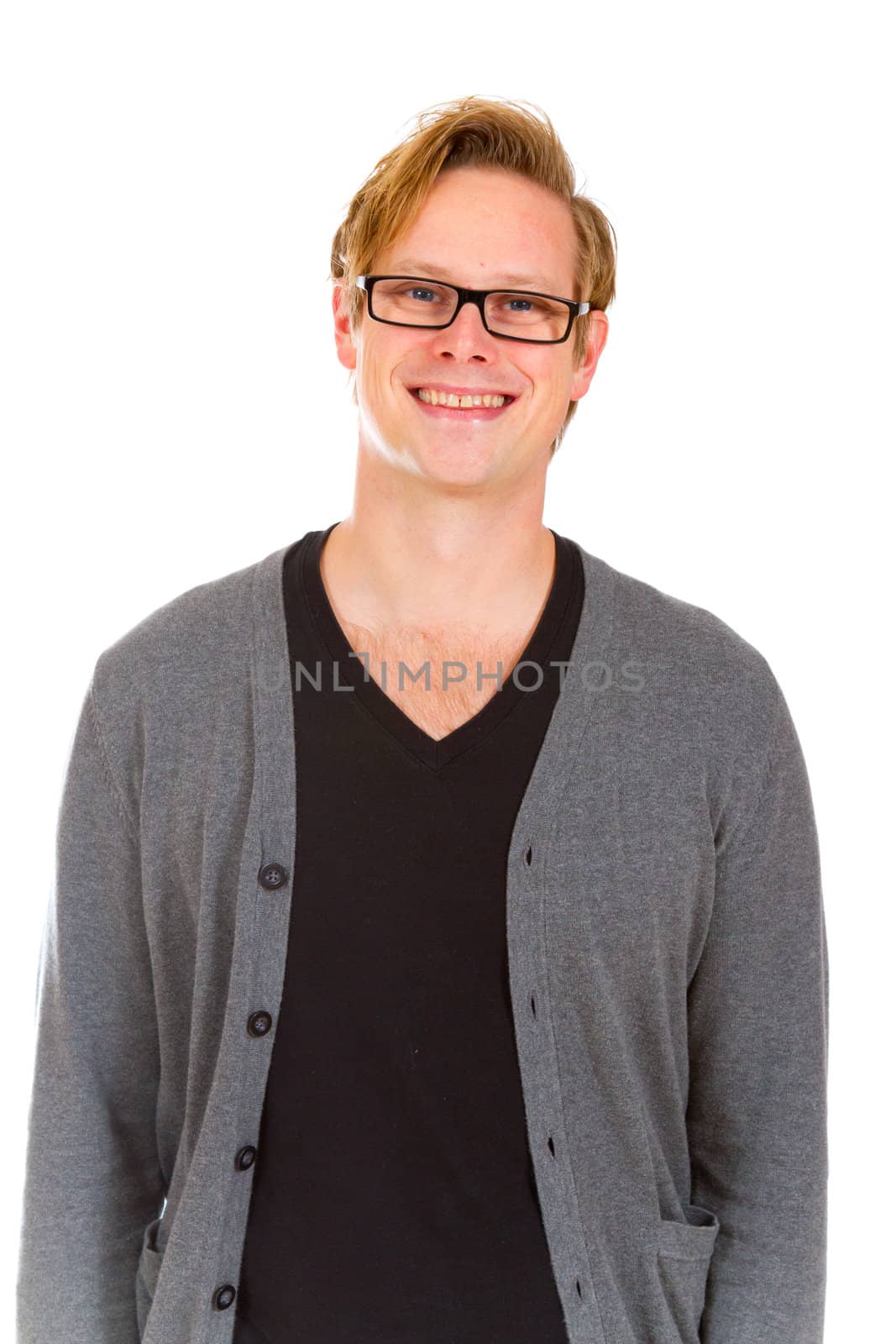 An attractive handsome man poses in the studio for a portrait against an isolated white background while wearing a black shirt and a grey cardigan sweater.