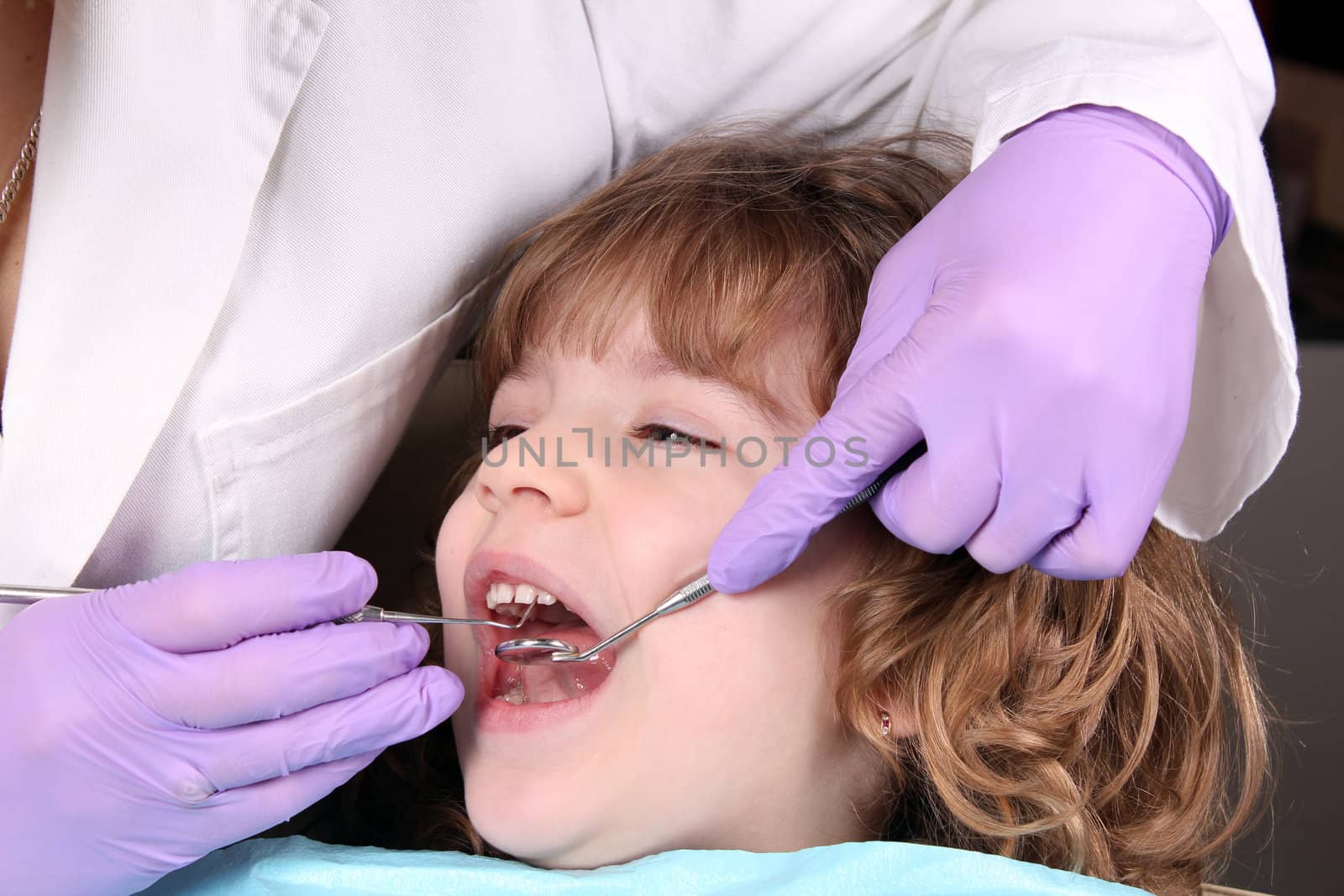 child patient at the dentist dental examine by goce