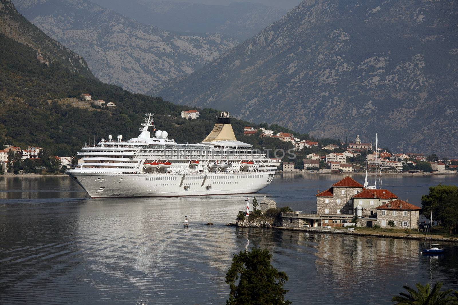 Small cruiser arriving in the inlet of Kotor - Montenegro.
