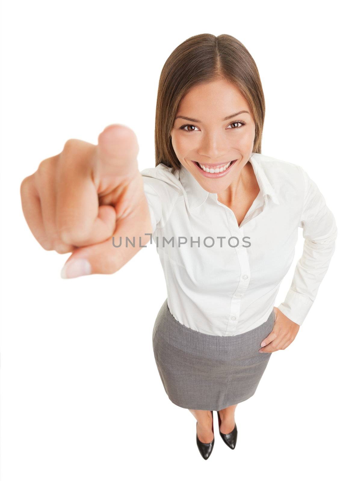 Positive business woman pointing her finger at camera isolated on white on white background, standing smiling happy in high angle. Mixed race Asian Caucasian business woman.