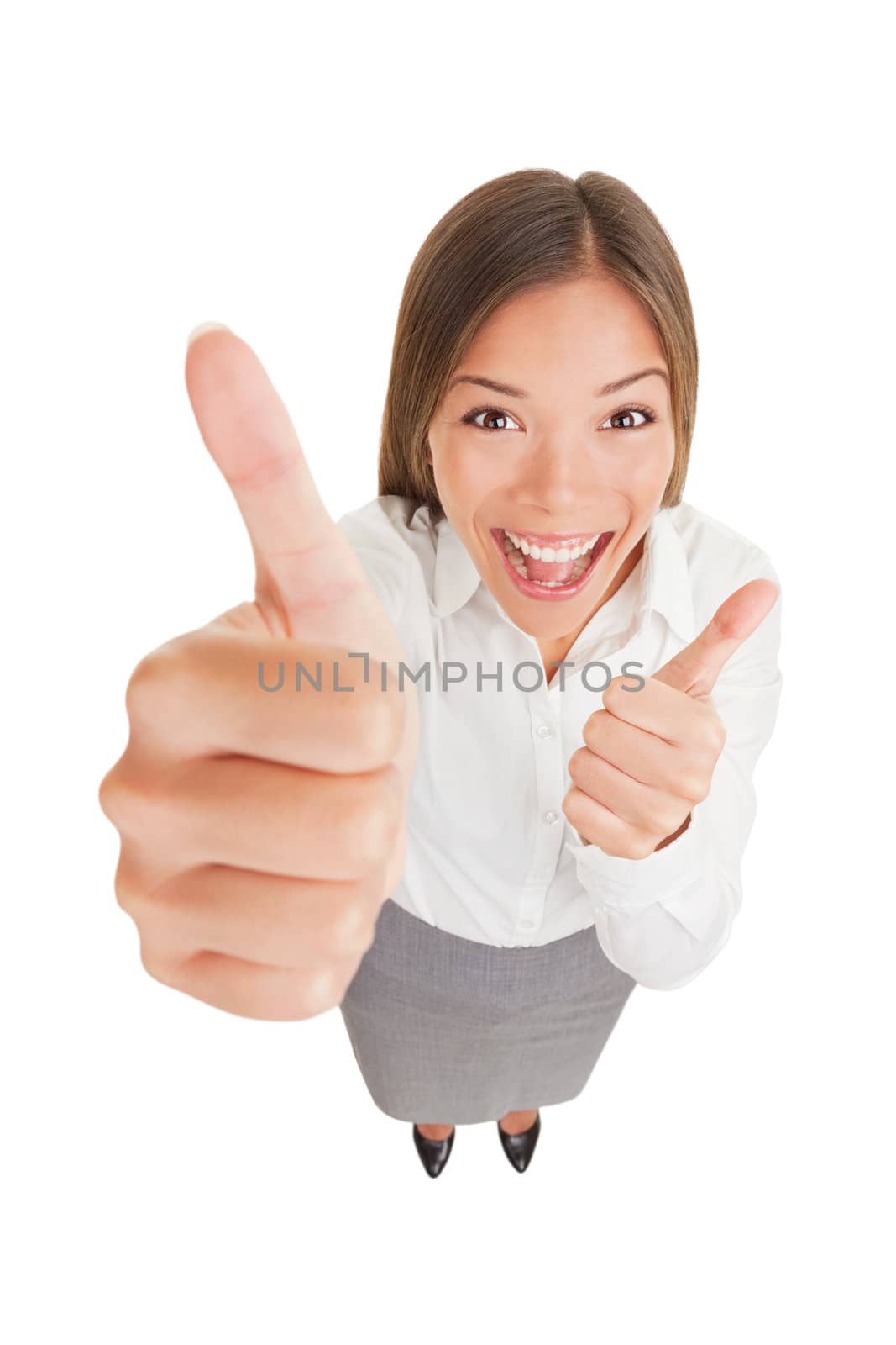 Happy excited woman giving thumbs up. Fun high angle view of laughing woman giving thumbs up with both hands showing enthusiasm isolated on white background in full length. Asian businesswoman.