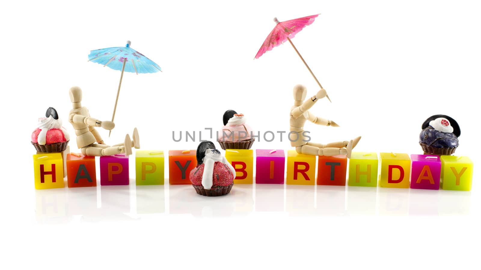 happy birthday with wooden puppet and cupcakes