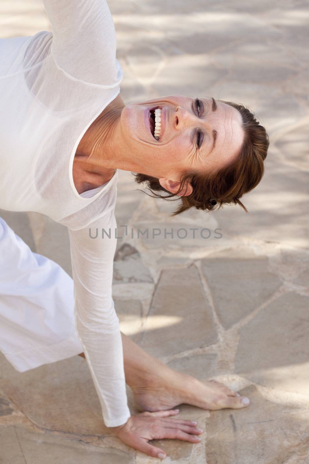 A flexibel middle age senior woman doing yoga