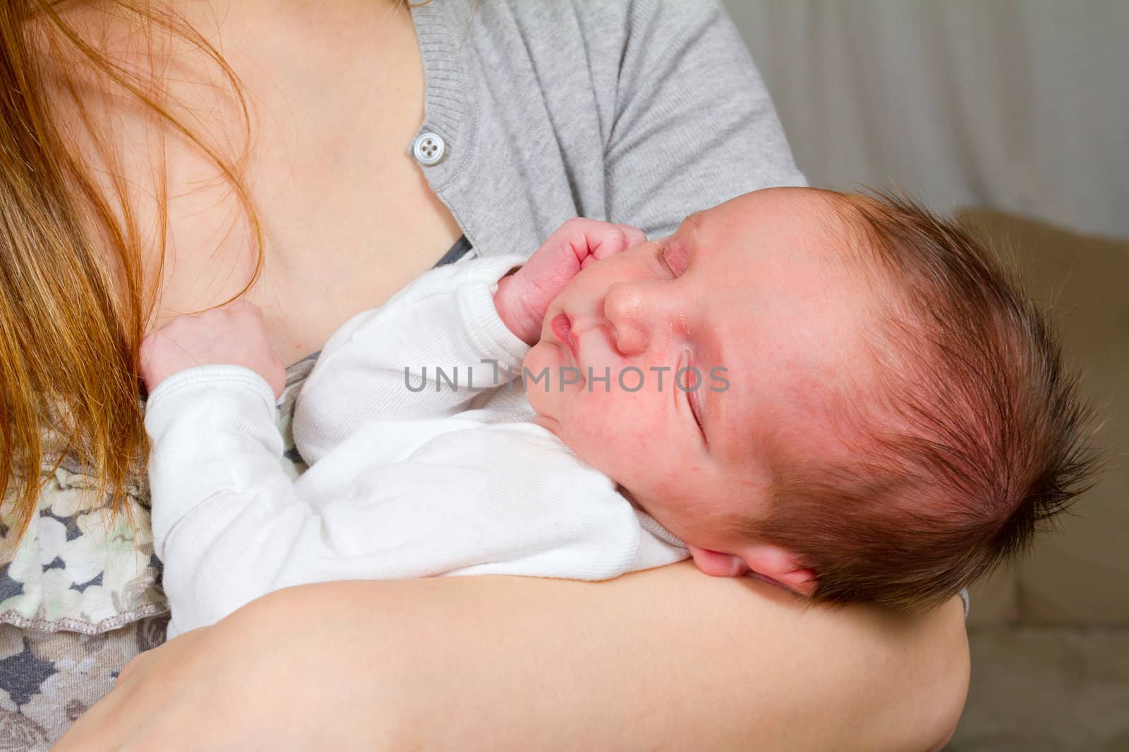 Mother Holding Newborn Baby Boy by joshuaraineyphotography