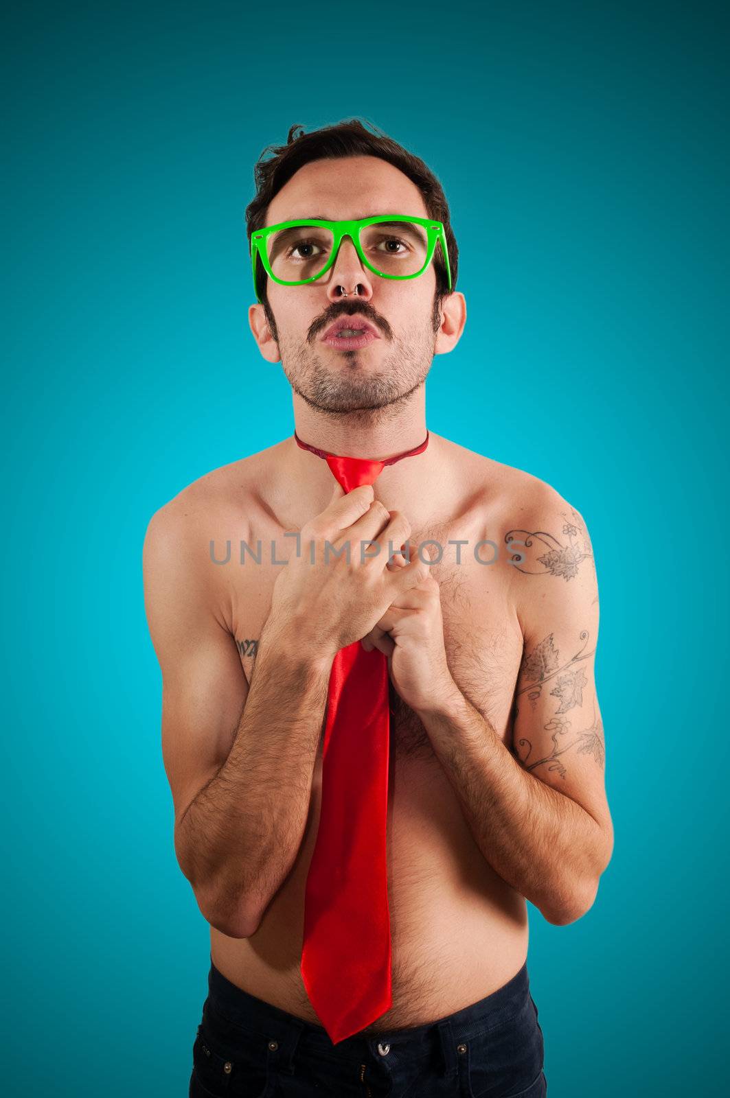 naked man wearing a red tie on blue background