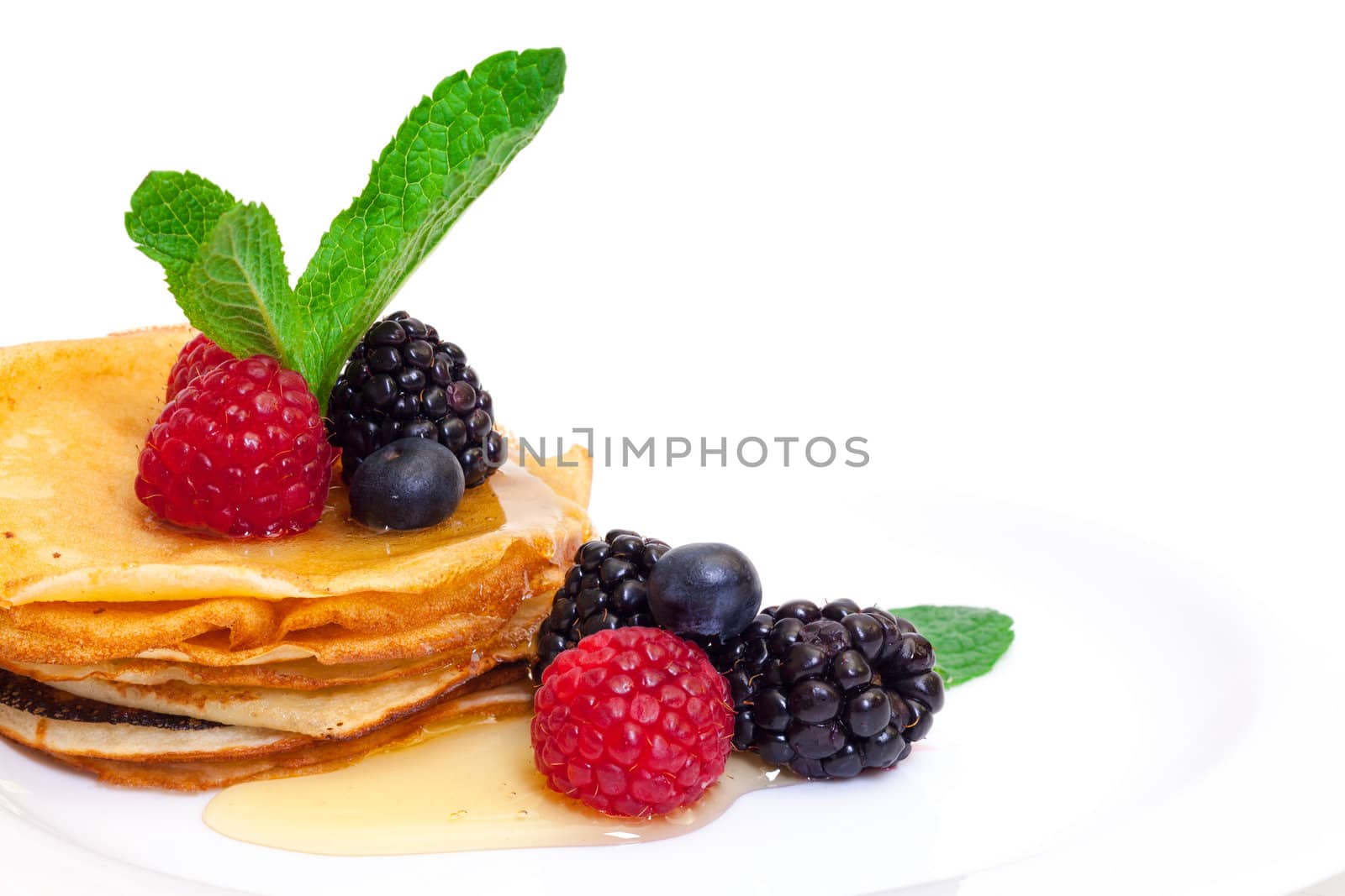 Delicious Freshly Prepared Pancakes with Honey and Berries on white background