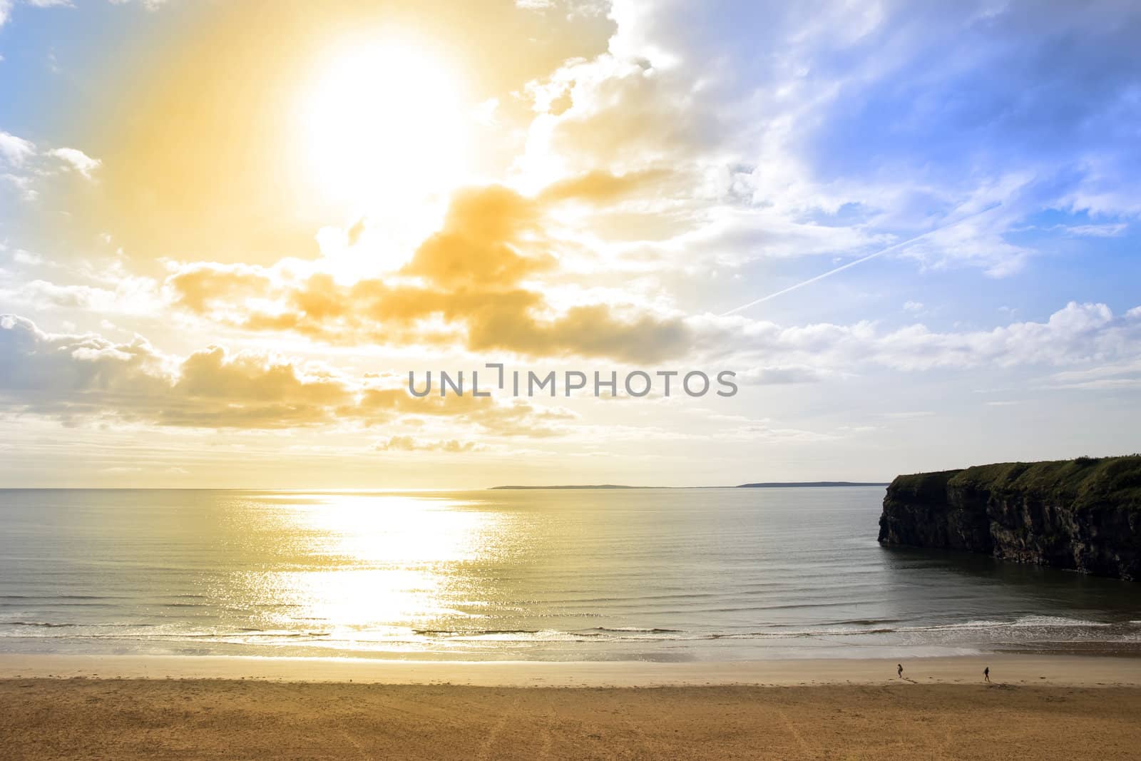golden sunshine over the Ballybunion beach and cliffs in Ireland on a summers day