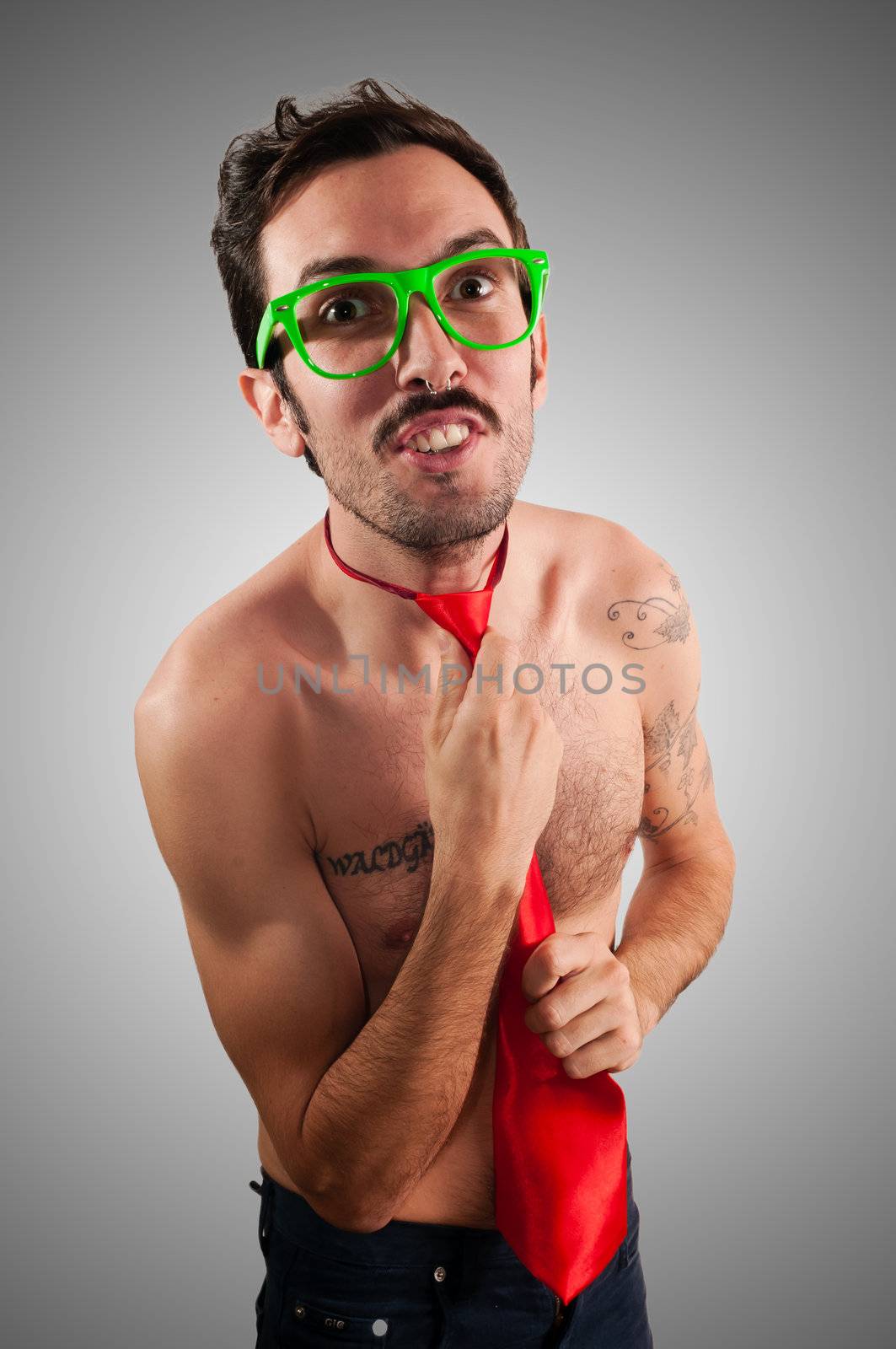 naked man wearing a red tie on gray background