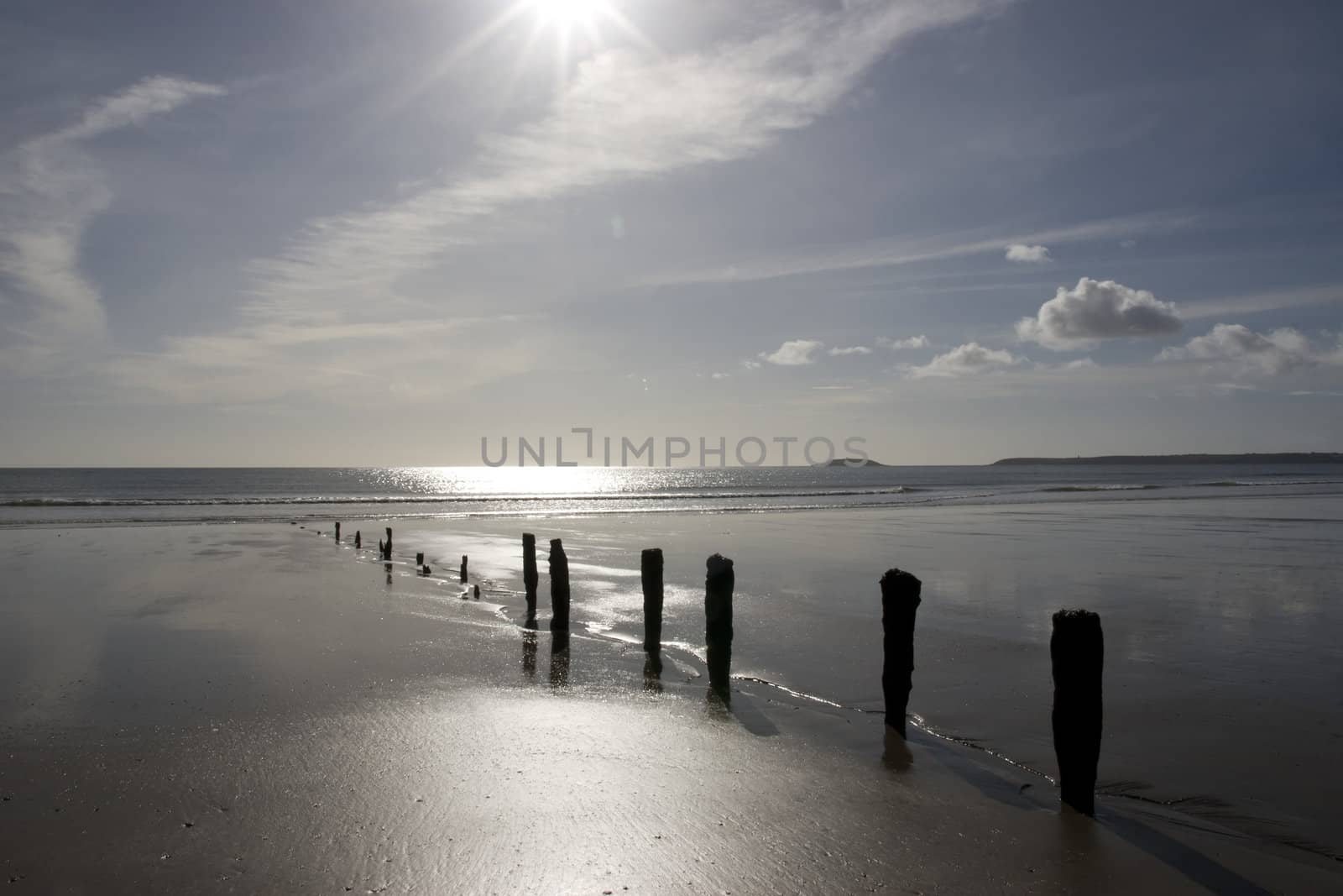 sunshine over the beach breakers in Youghal county Cork Ireland on a summers day