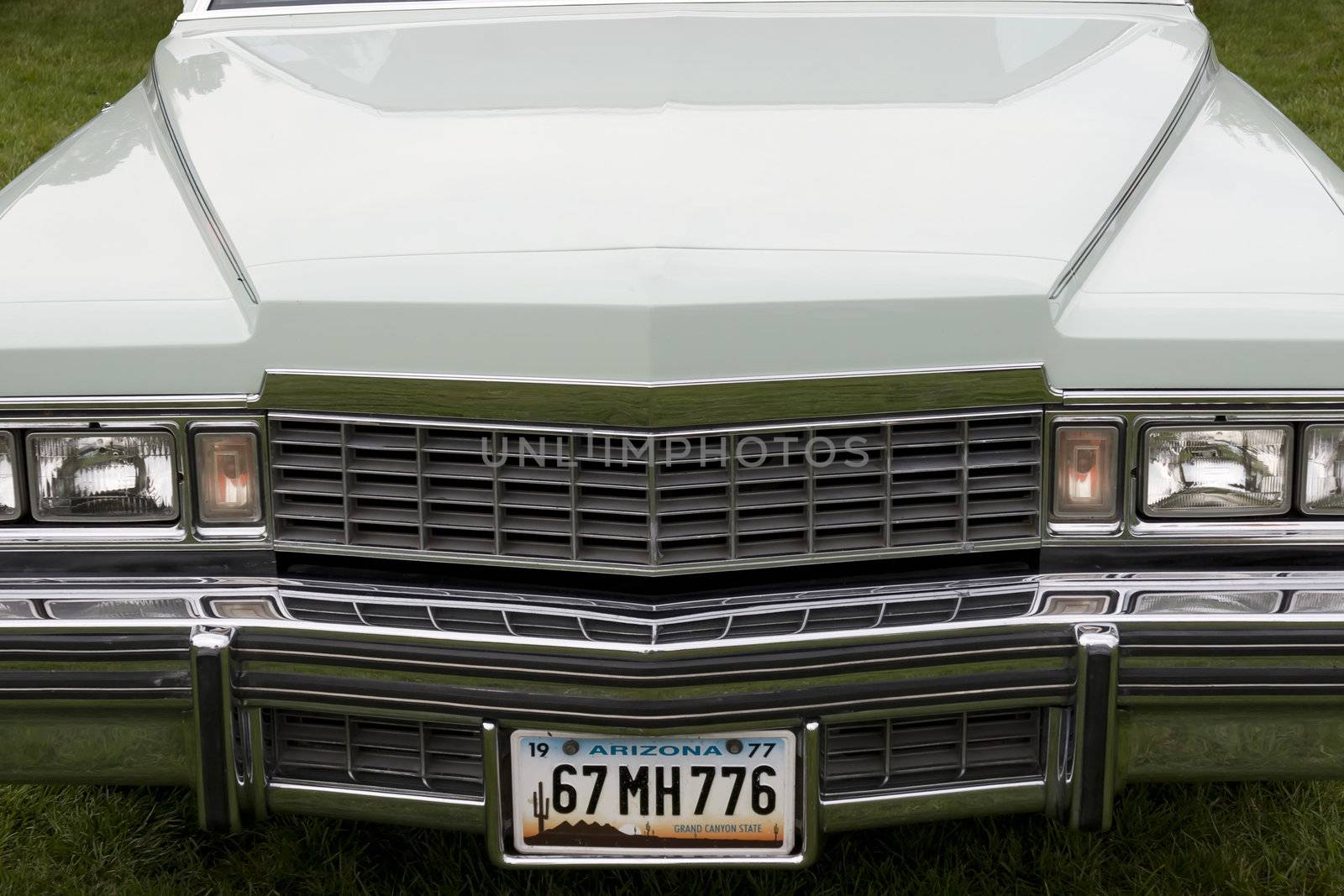 the hood of a classic American car with an altered number plate