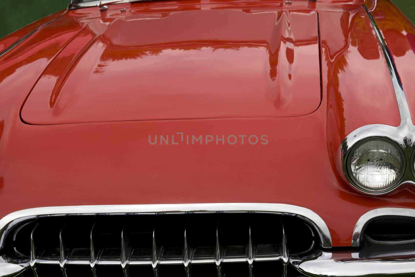 the hood of a classic red sports car