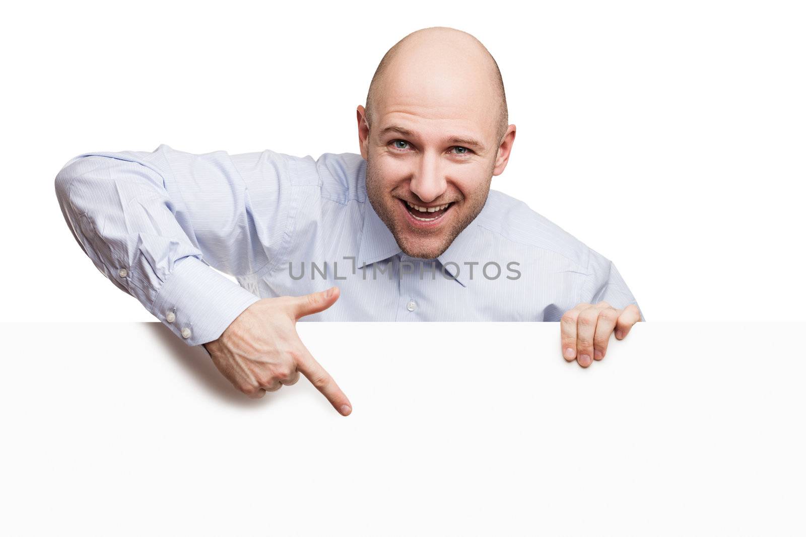 Handsome smiling bald or shaved head man holding blank sign or placard white isolated