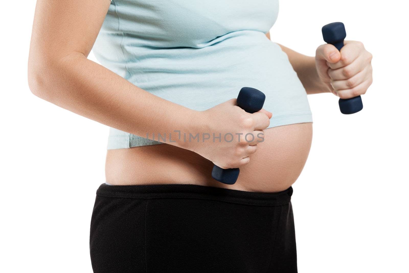 Pregnant woman holding fitness dumbbells by ia_64