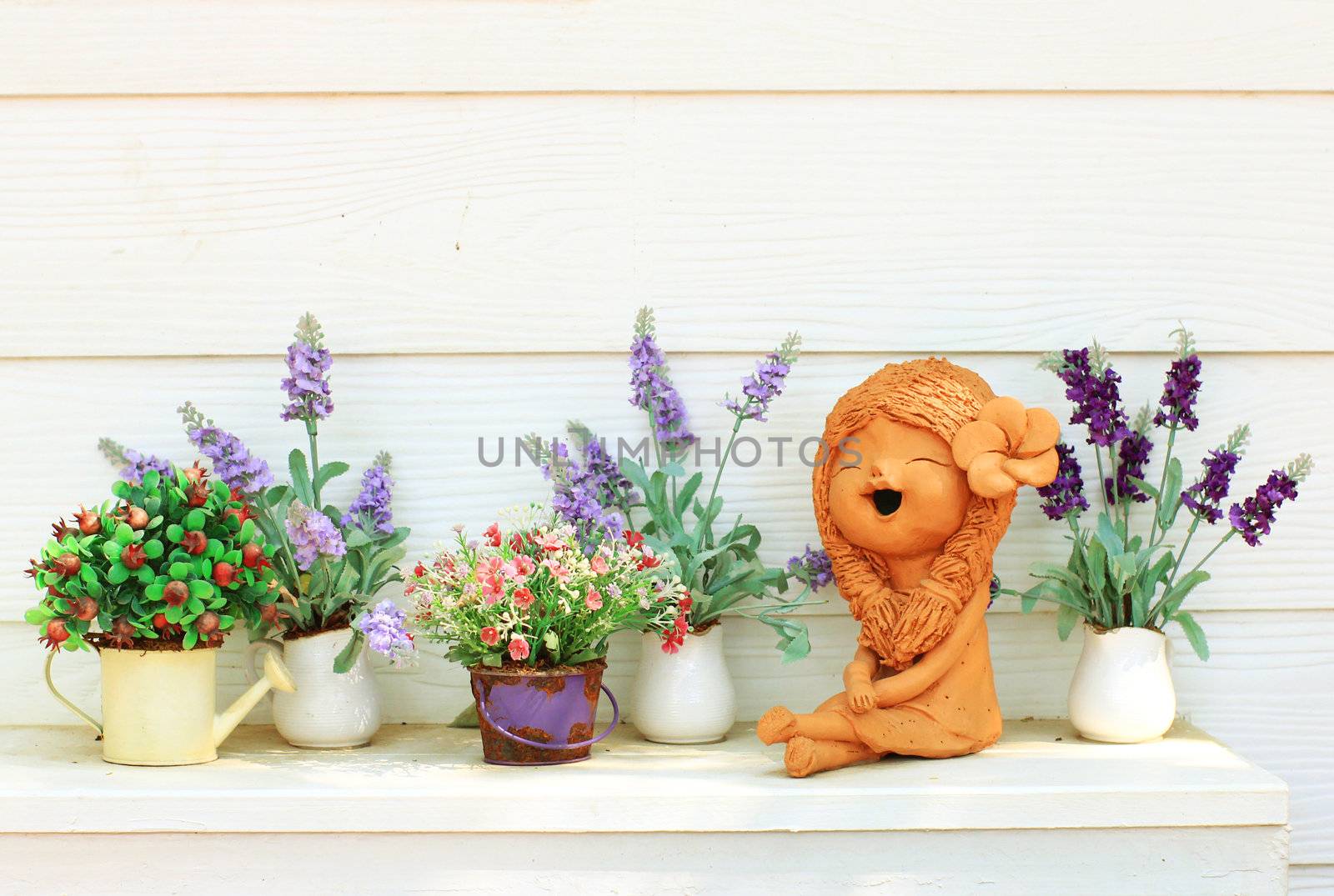 Doll clay and flower in ornamental garden  by nuchylee