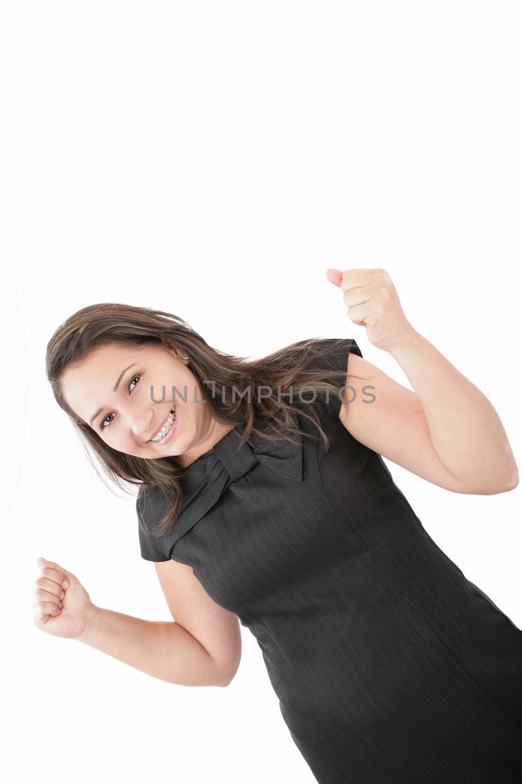 Woman with orthodontics enjoying success with clenched fists by dacasdo