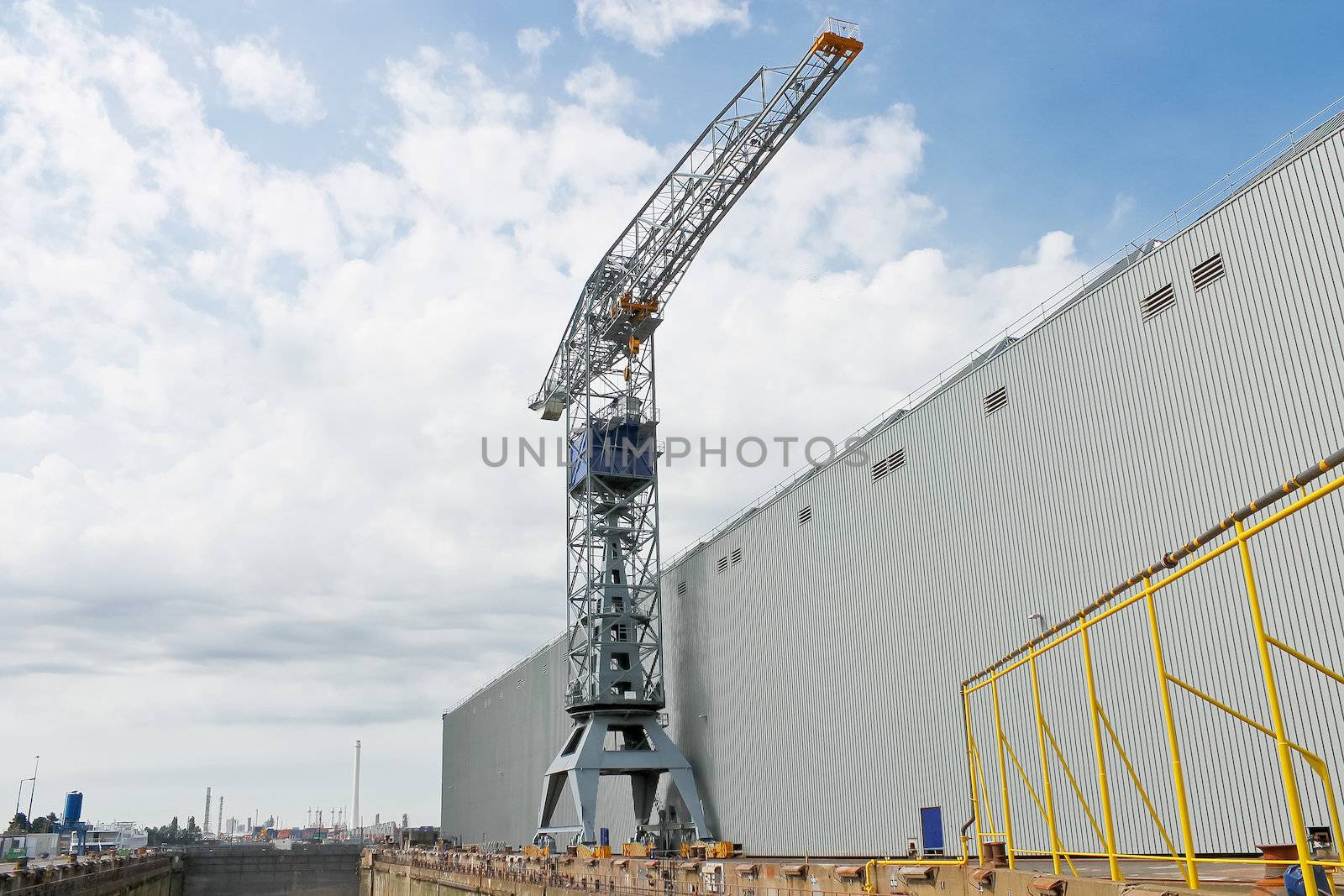 Crane near a covered dry dock at the shipyard by NickNick