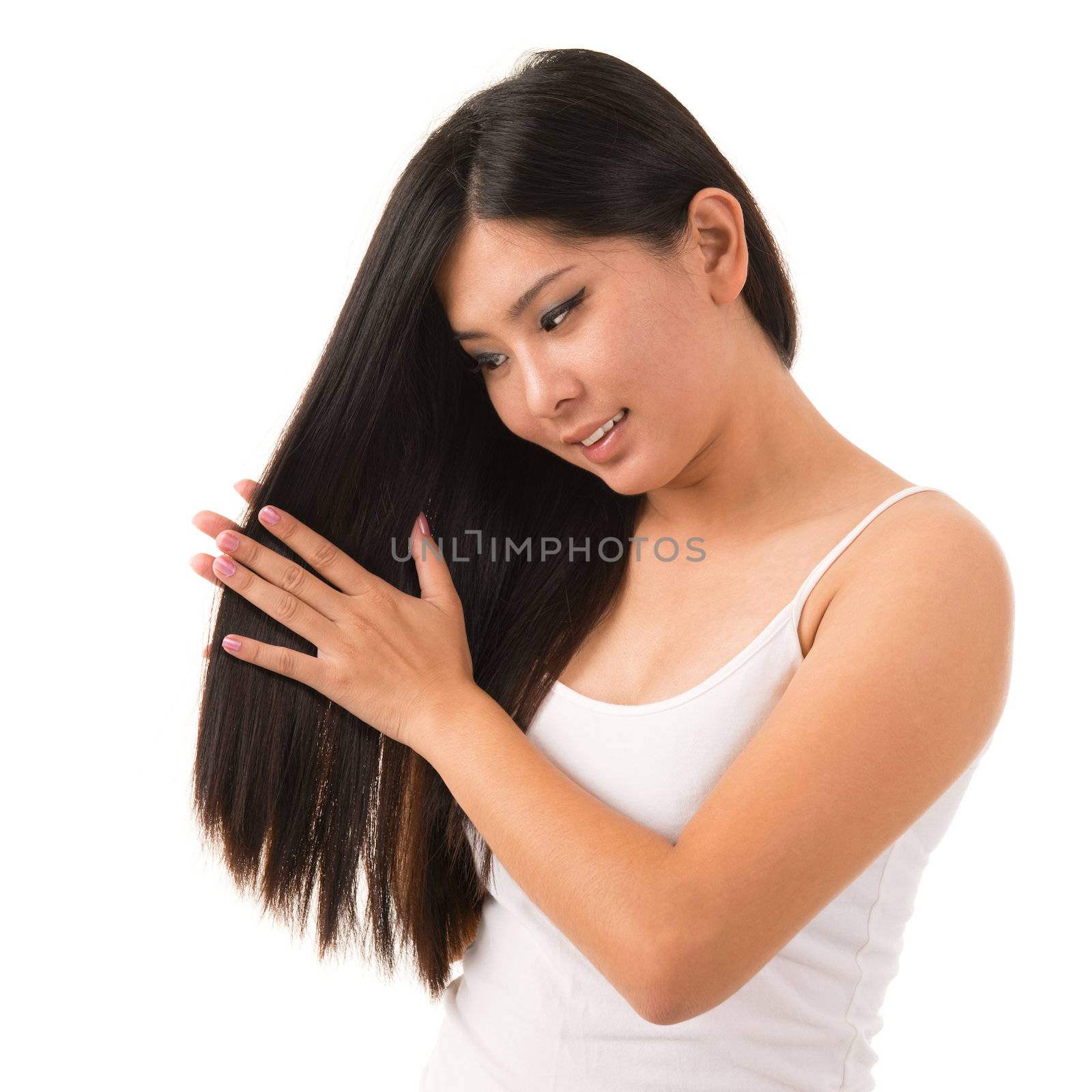 Beautiful Asian woman applying hair cream, isolated on white background