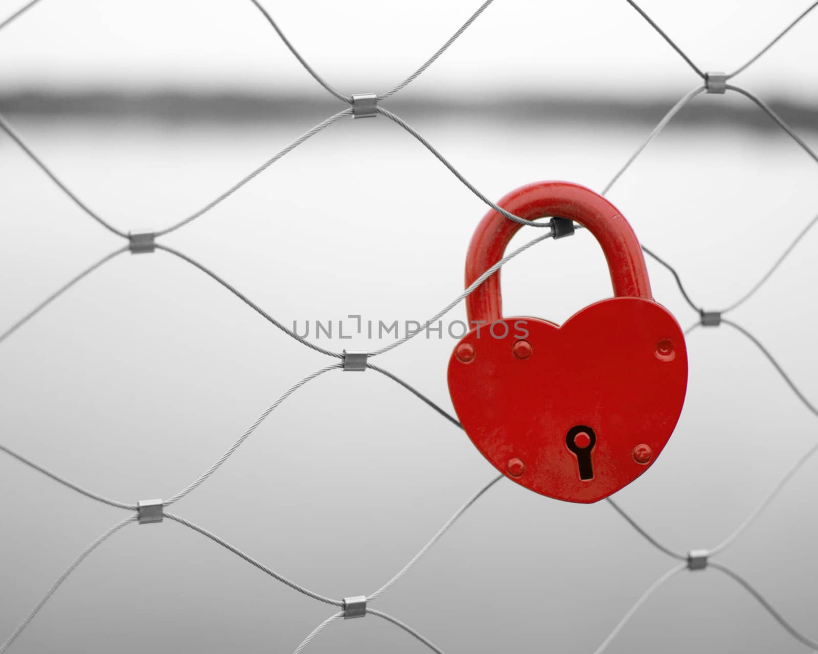 Love padlock on a bridge fence by only4denn