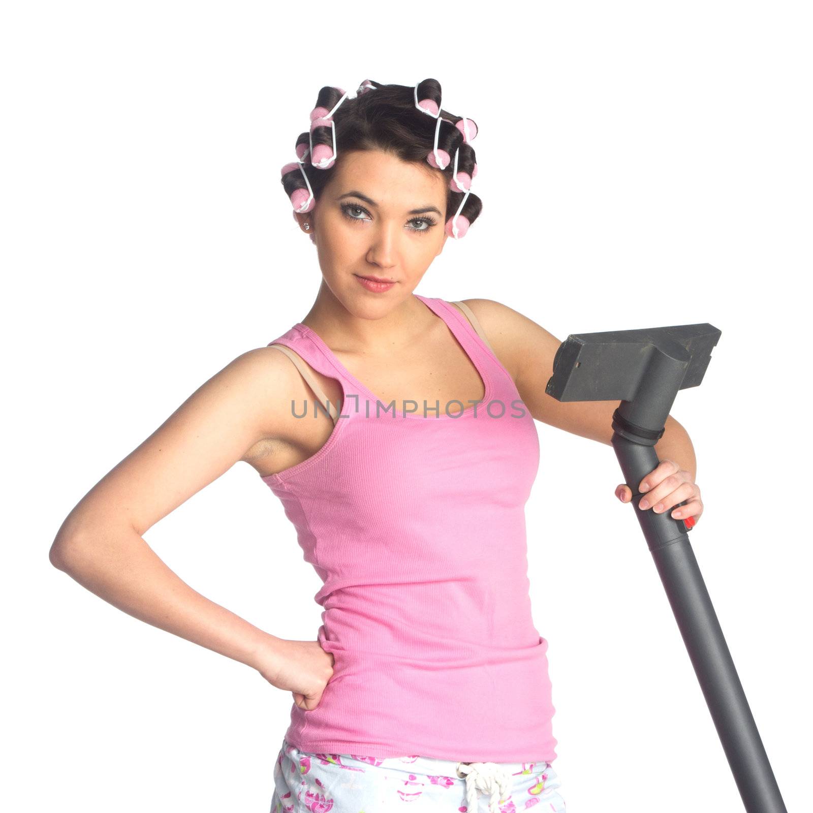 Funny girl with hair curlers on her head with vacuum cleaner isolated on white