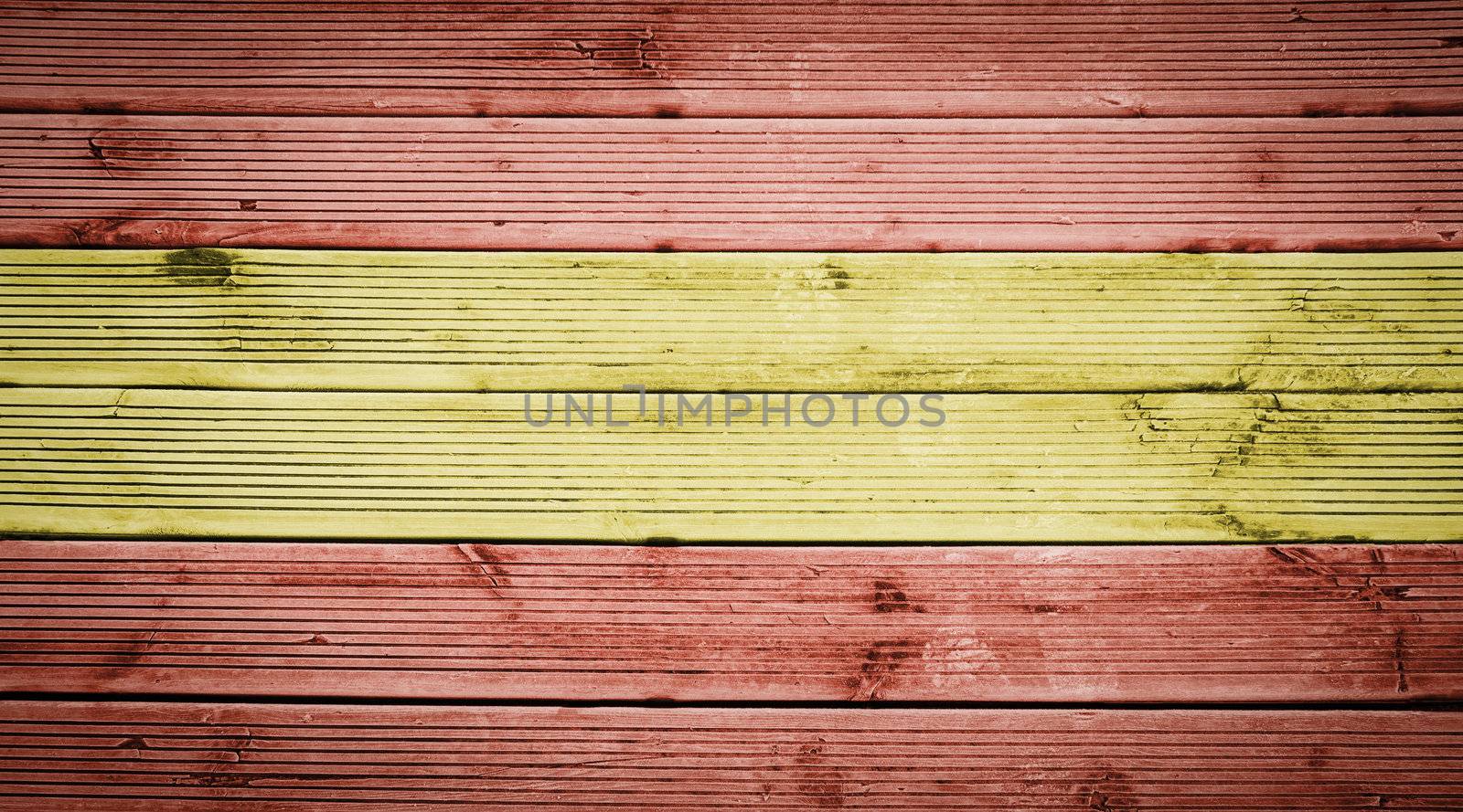 Natural wood planks texture background with the colors of the flag of Spain