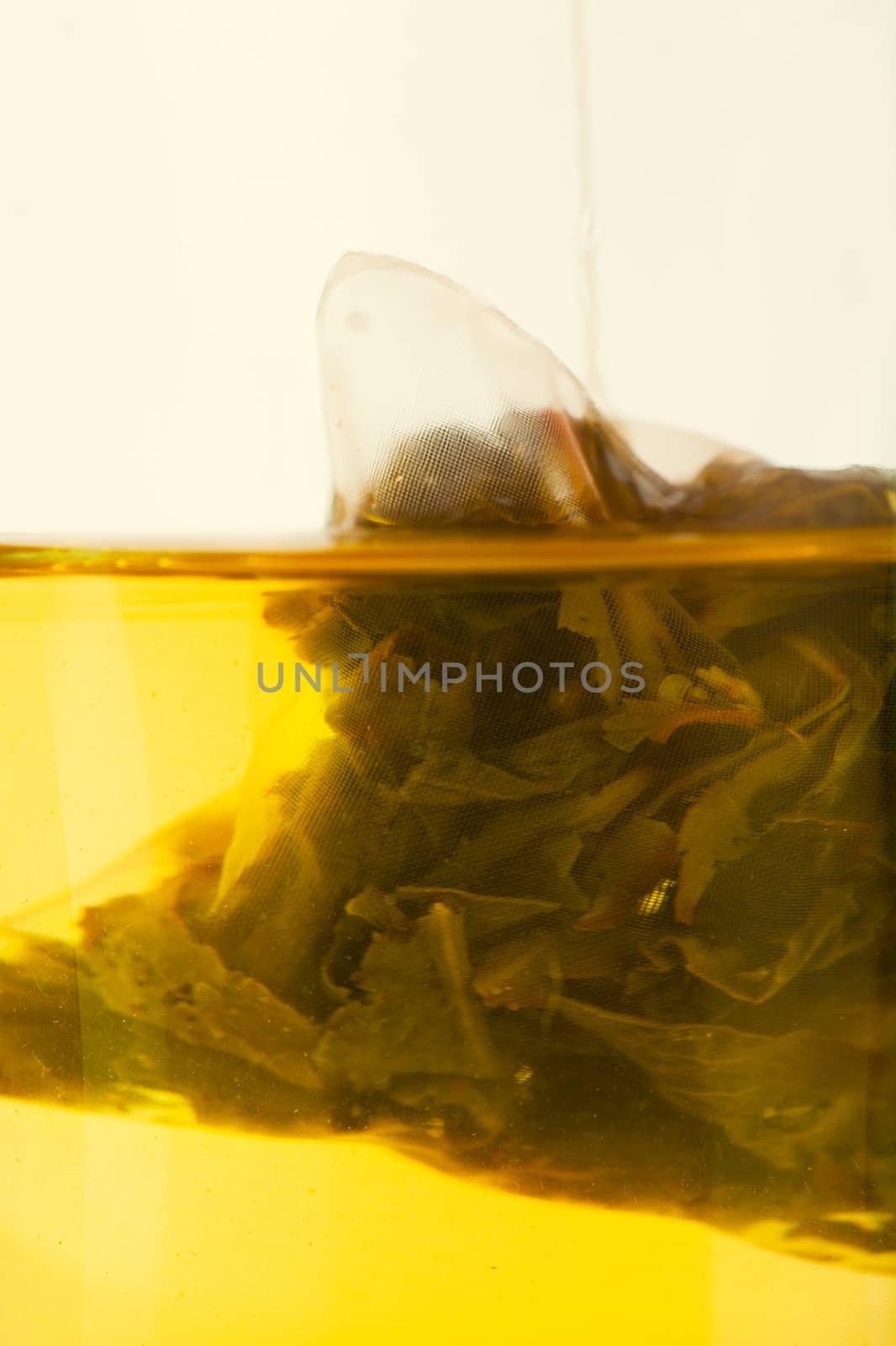 Macro view of teabag brewing in a transparent cup