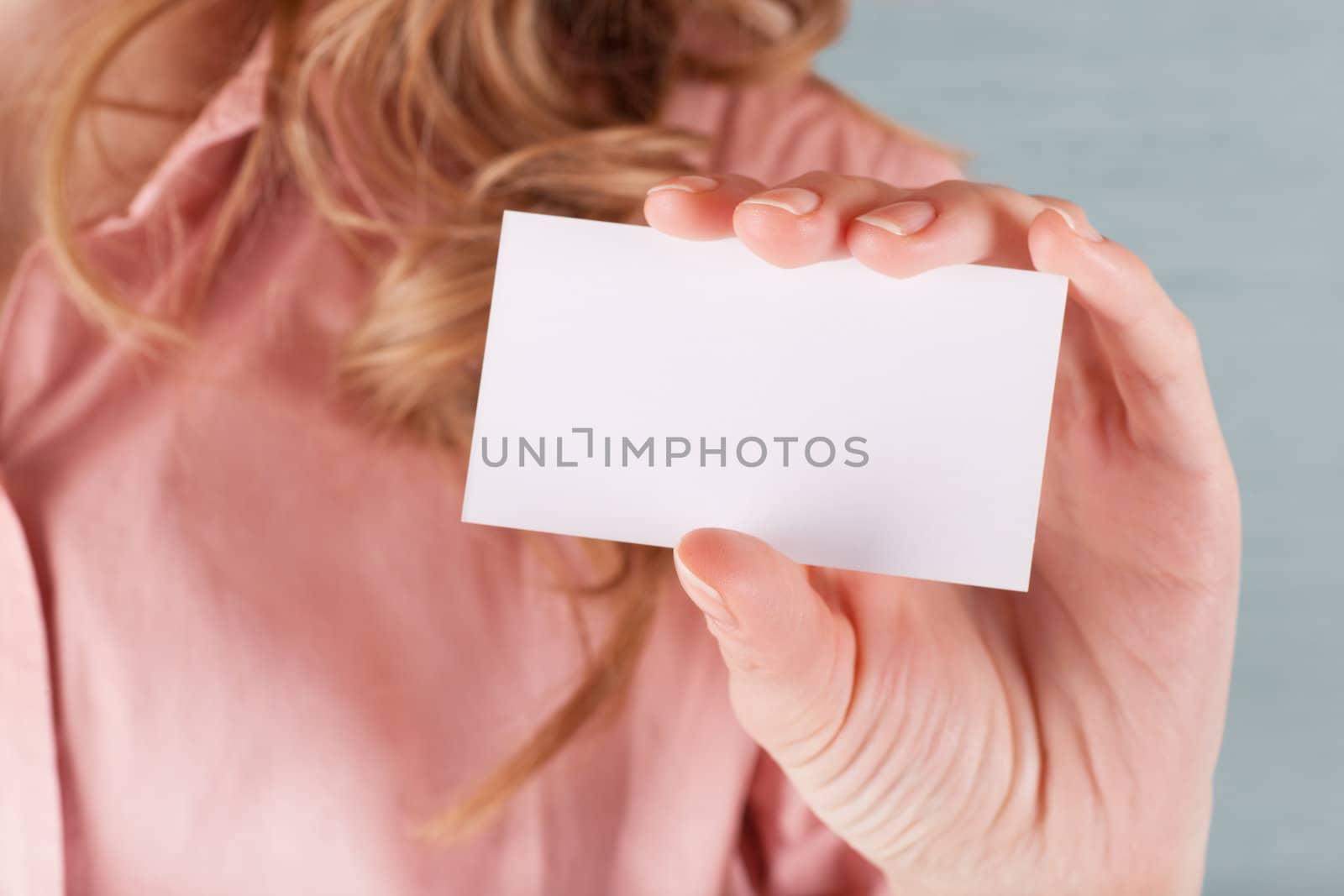 Image of business woman holding her visiting card