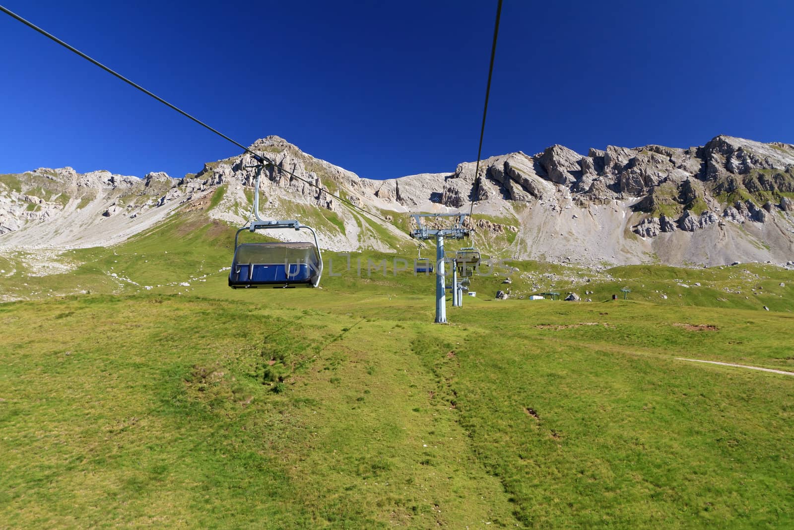 summer landscape of Alpine pasture with chairlift