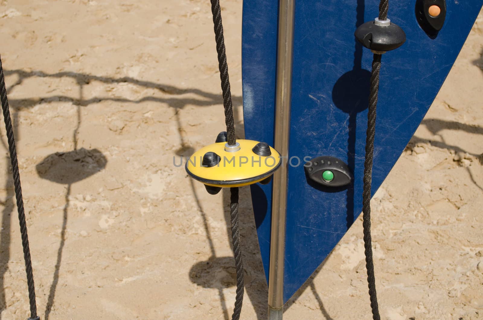 kid playground on sea beach sand. climbing equipment rope tool.