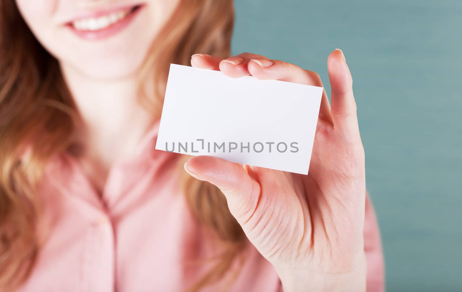 Image of smiling business woman holding her visiting card