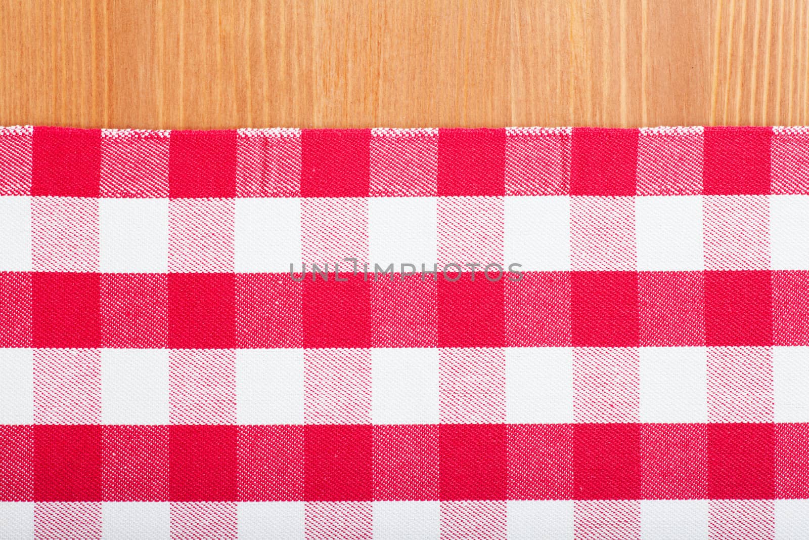 Checked with red and white tablecloth on a wooden table