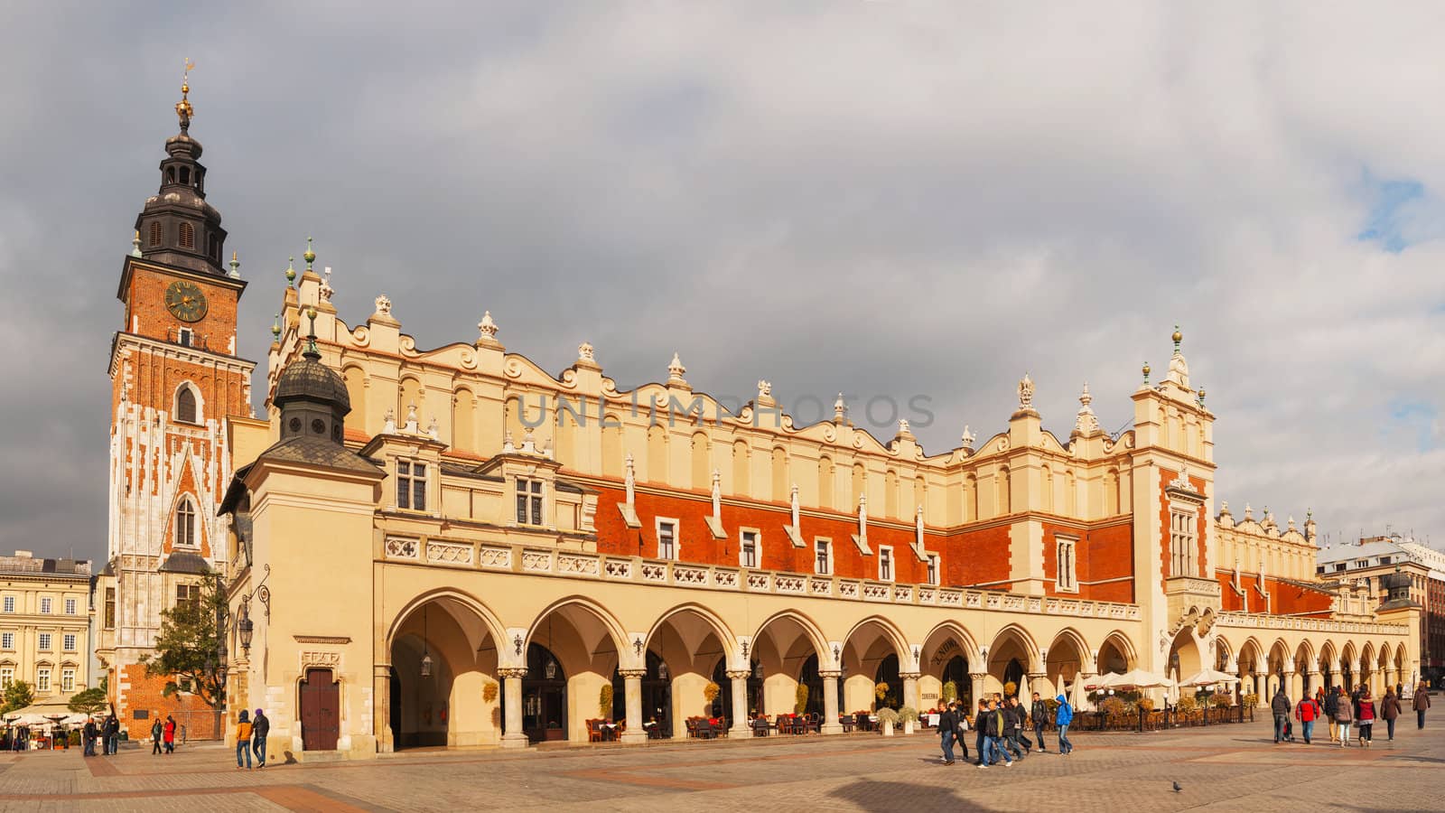 KRAKOW, POLAND - OCTOBER 11: Old market square with tourists on October 11, 2012 in Krakow. It's a principal urban space located at the center of the city and – at roughly 40,000 sq. m – it is the largest medieval town square in Europe.