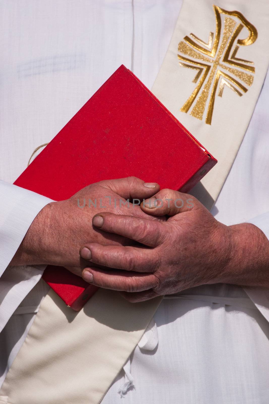 Folded hands of a catholic priest