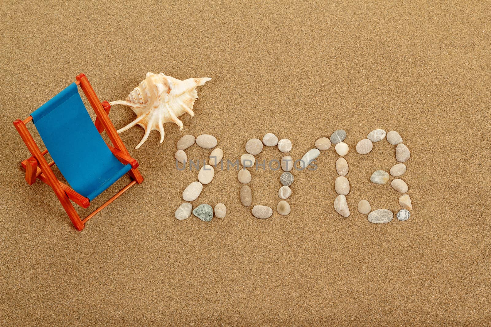 vacation background with sun lounger, sea shell and text 2013 from stones