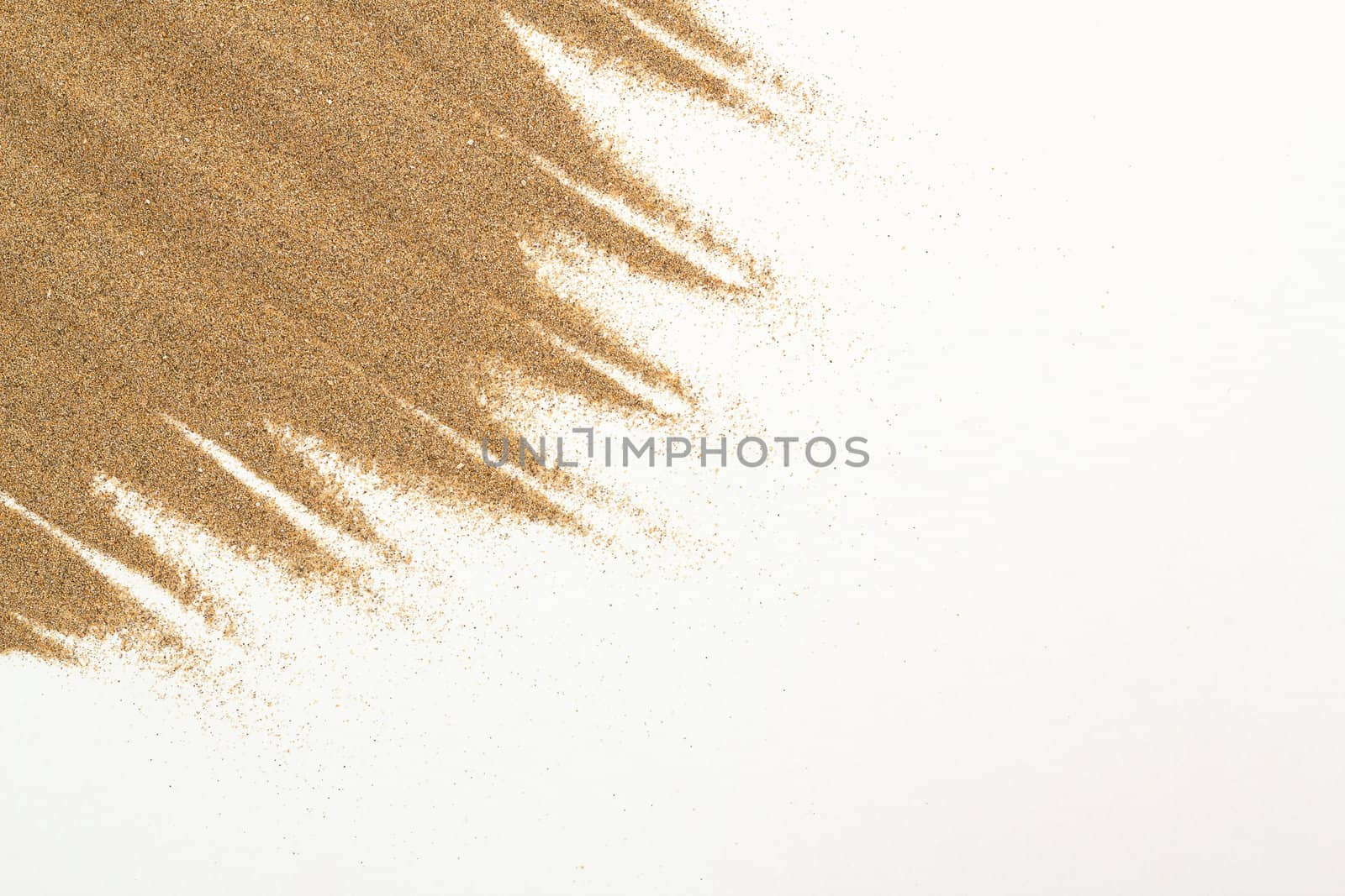 closeup of sand on a white for background or backdrop use