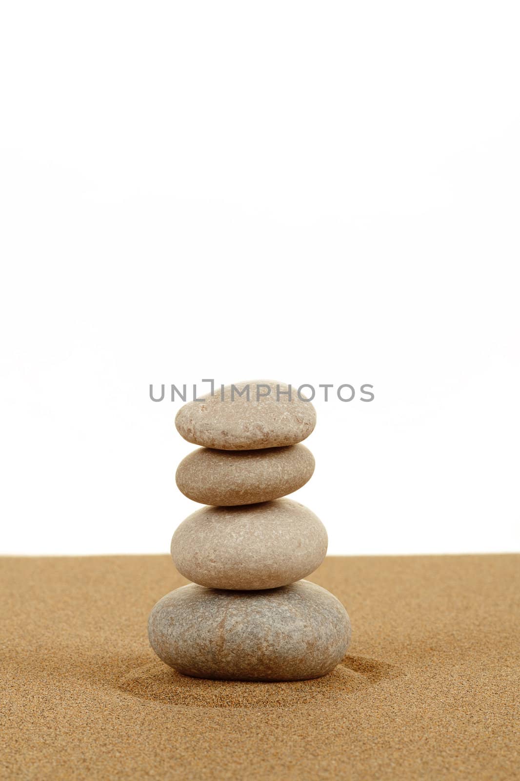 Balance zen stones in sand on white background